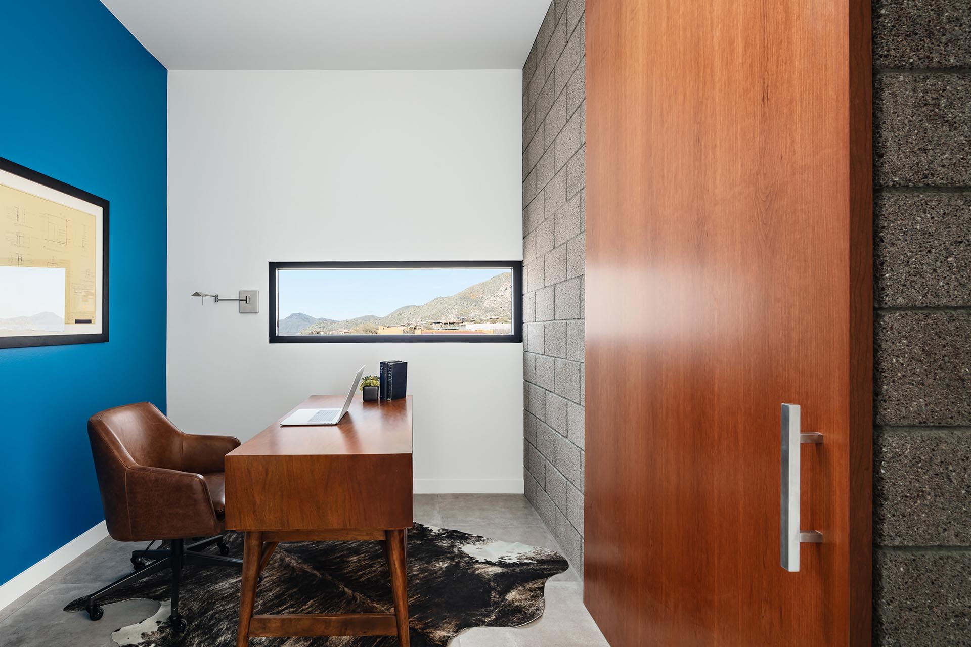 A full height barn door hides a home office by the master suite.