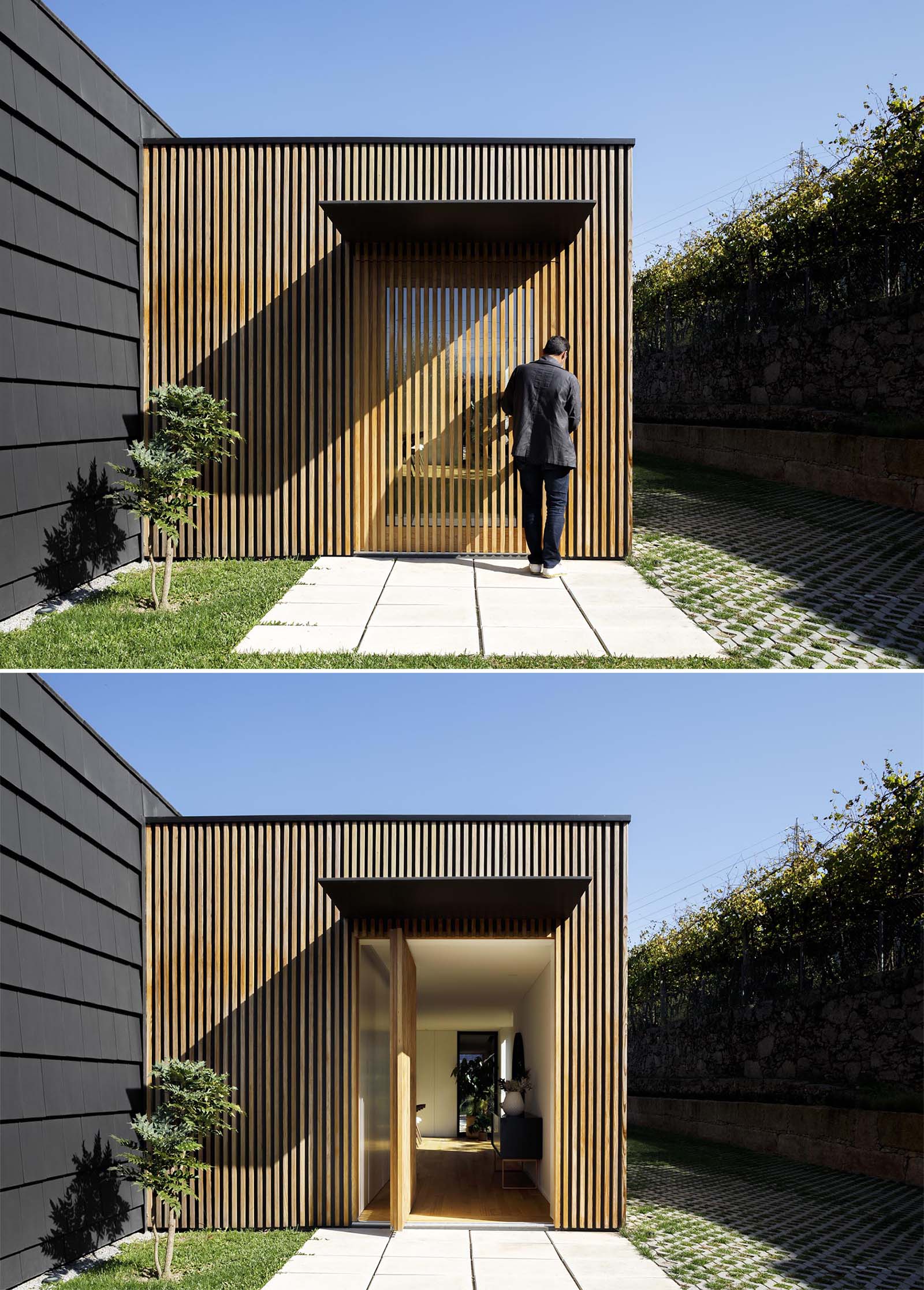 A modern home with a glass front door hidden from view with a wood slat wall.