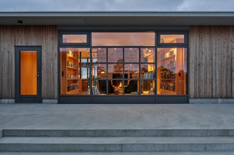 A modern house with a wood and glass facade.