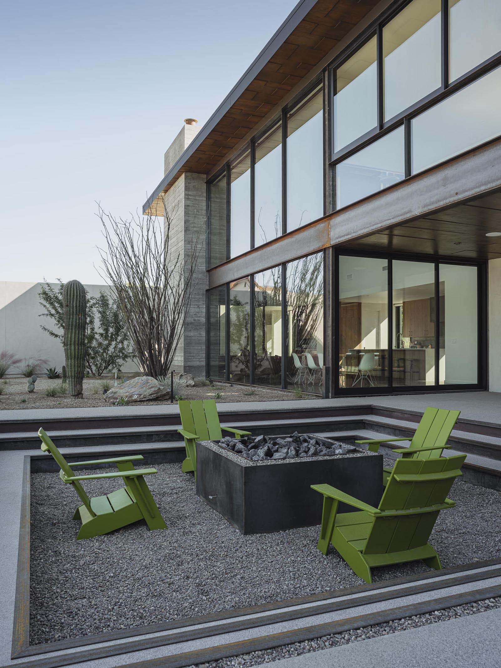 A modern desert home with a sunken fire pit.