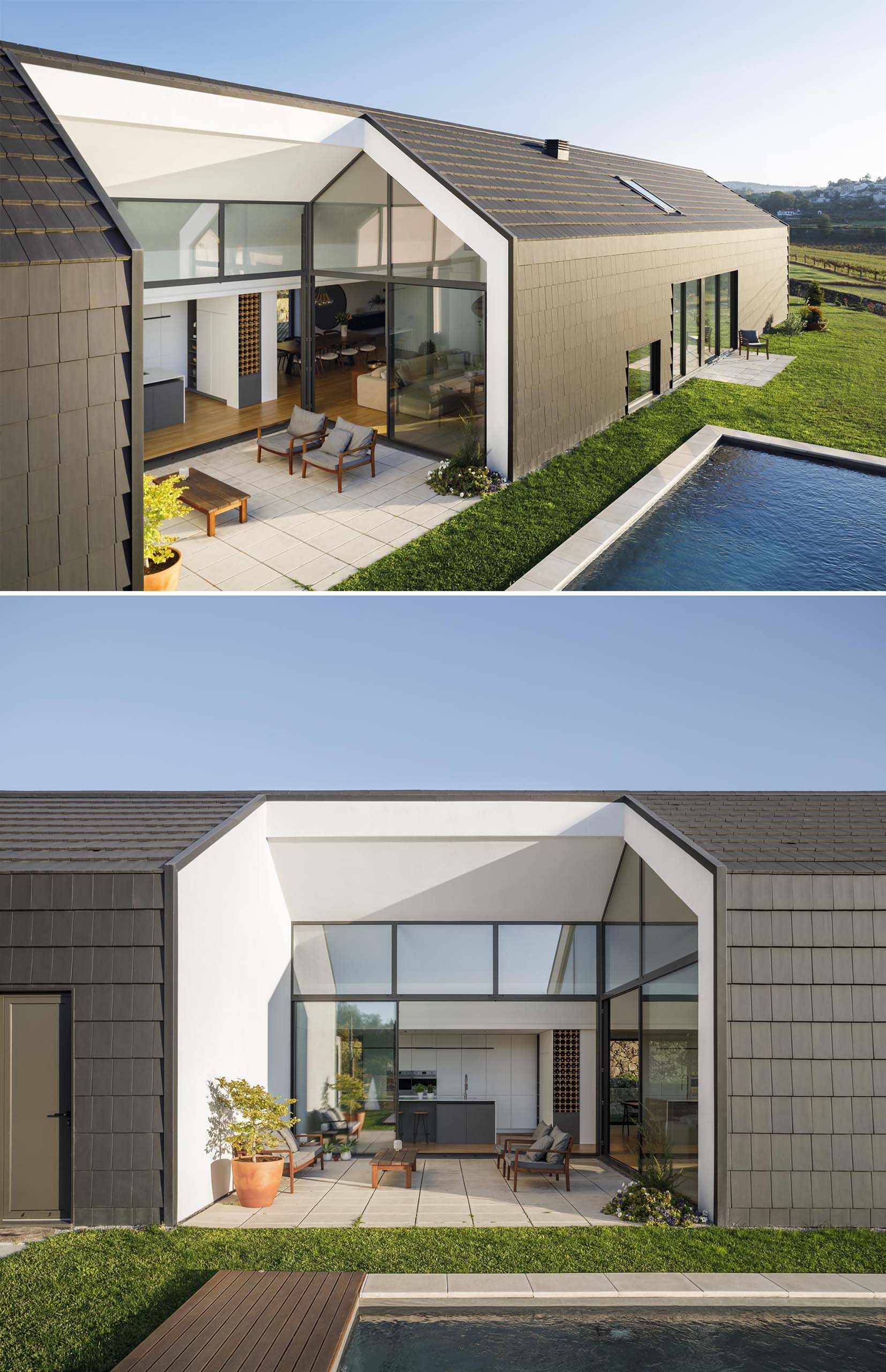 A modern house open to a small patio, the yard, and a swimming pool.