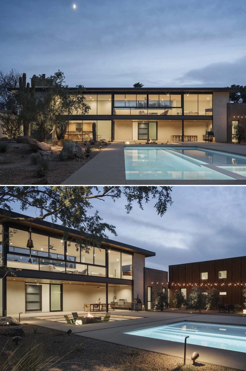 A modern home with a swimming pool, sunken fire pit, and outdoor dining.