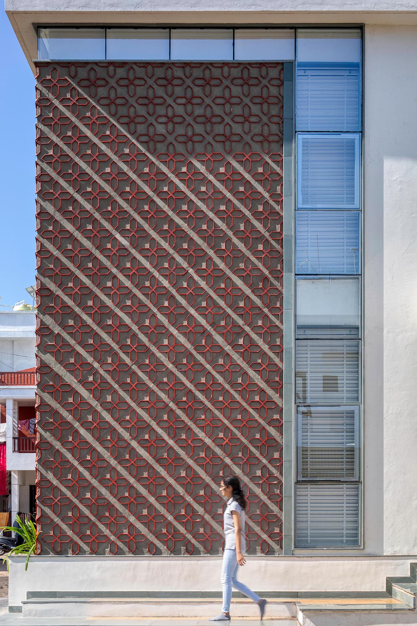 A unique patterned accent wall on a modern house facade.