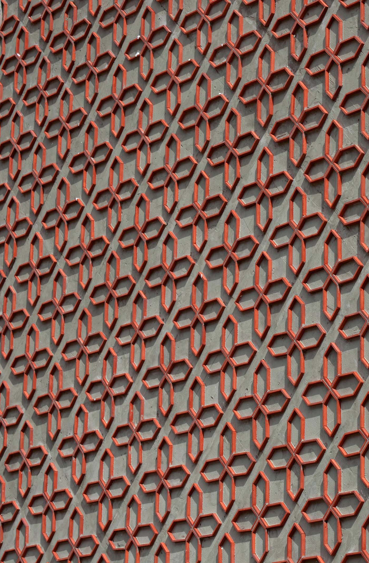 A patterned wall made from cut clay roof tiles.