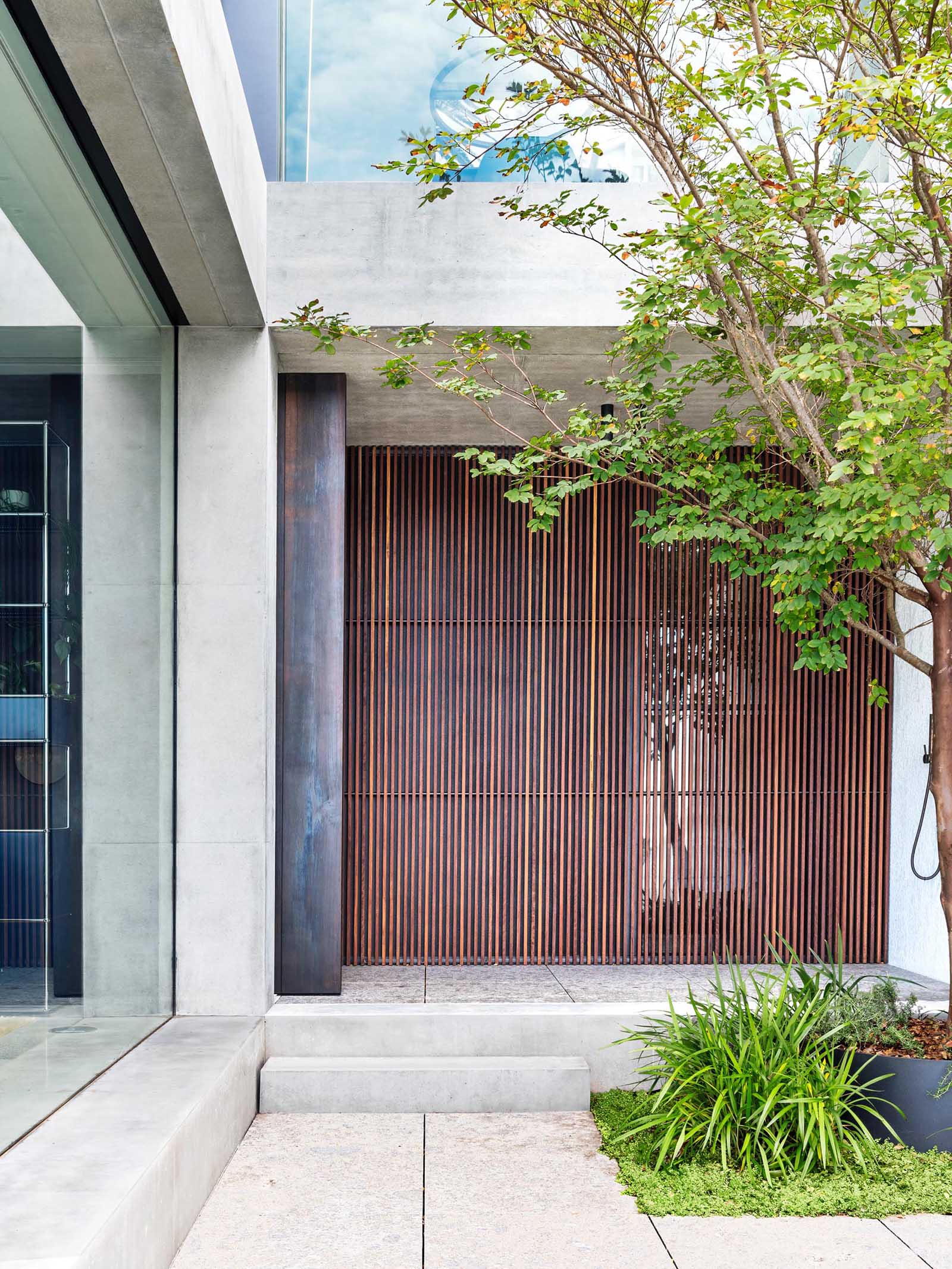 A modern wood slat wall alongside an outdoor shower.