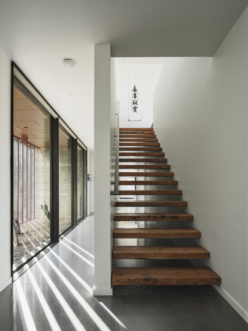 Wood stairs connect the lower level of the home with the upper floor.