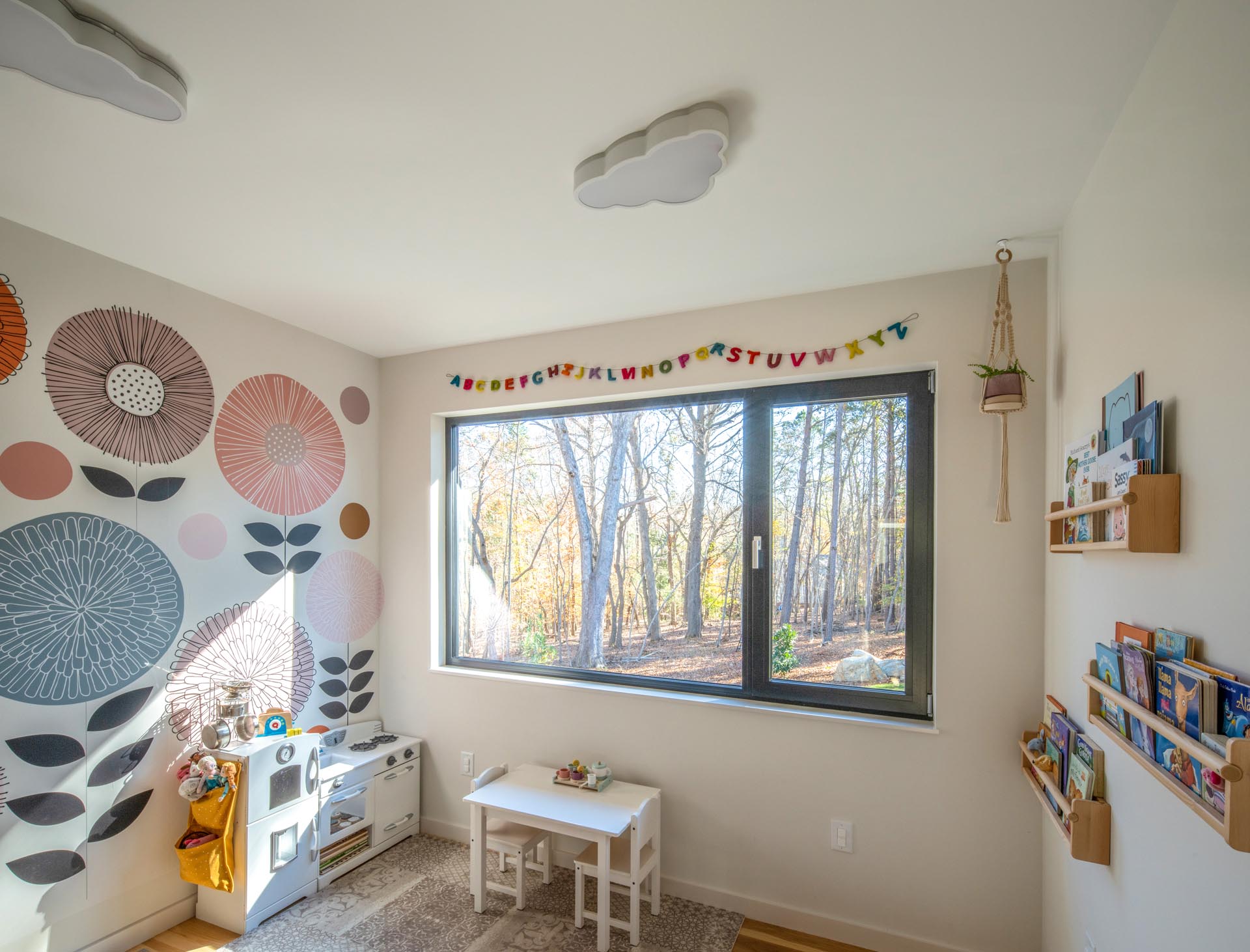 A modern playroom/nursery for the kids that they can each access from their respective bedrooms.