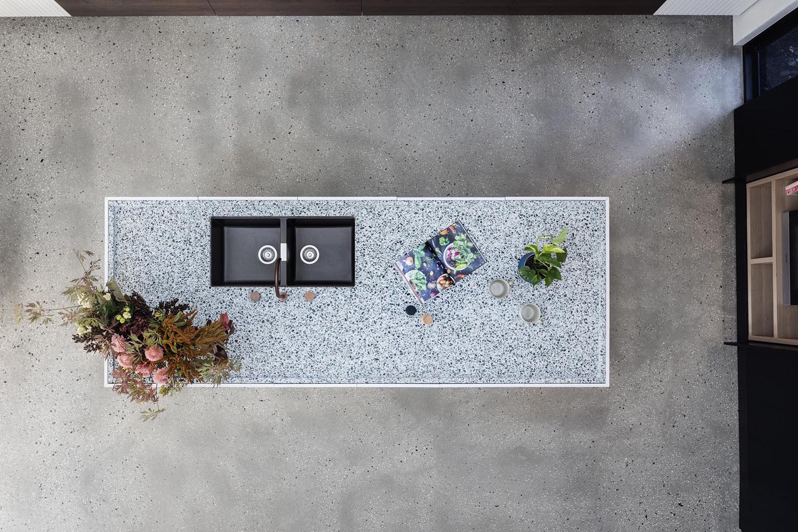 A modern kitchen with an island that has an inset countertop.