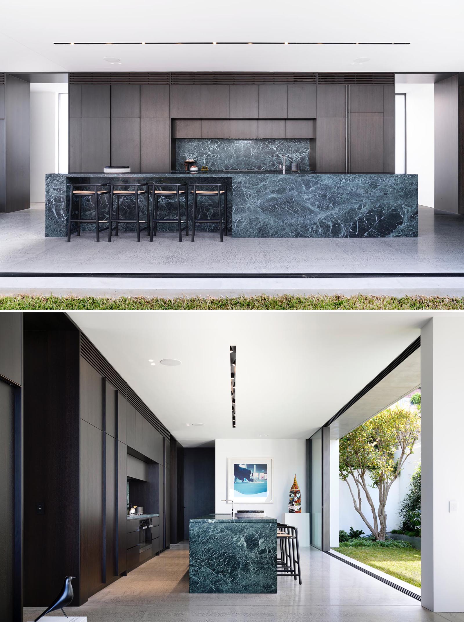 In this modern kitchen, dark wood cabinets complement the gray/black feature marble used on the island and backsplash.