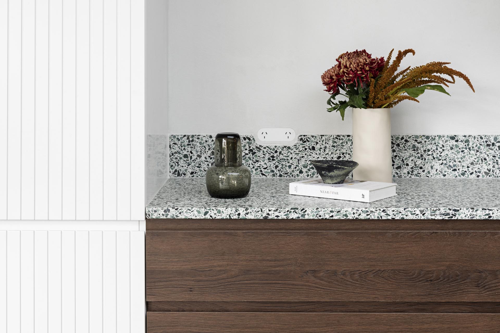 A modern kitchen with wood and white cabinets.