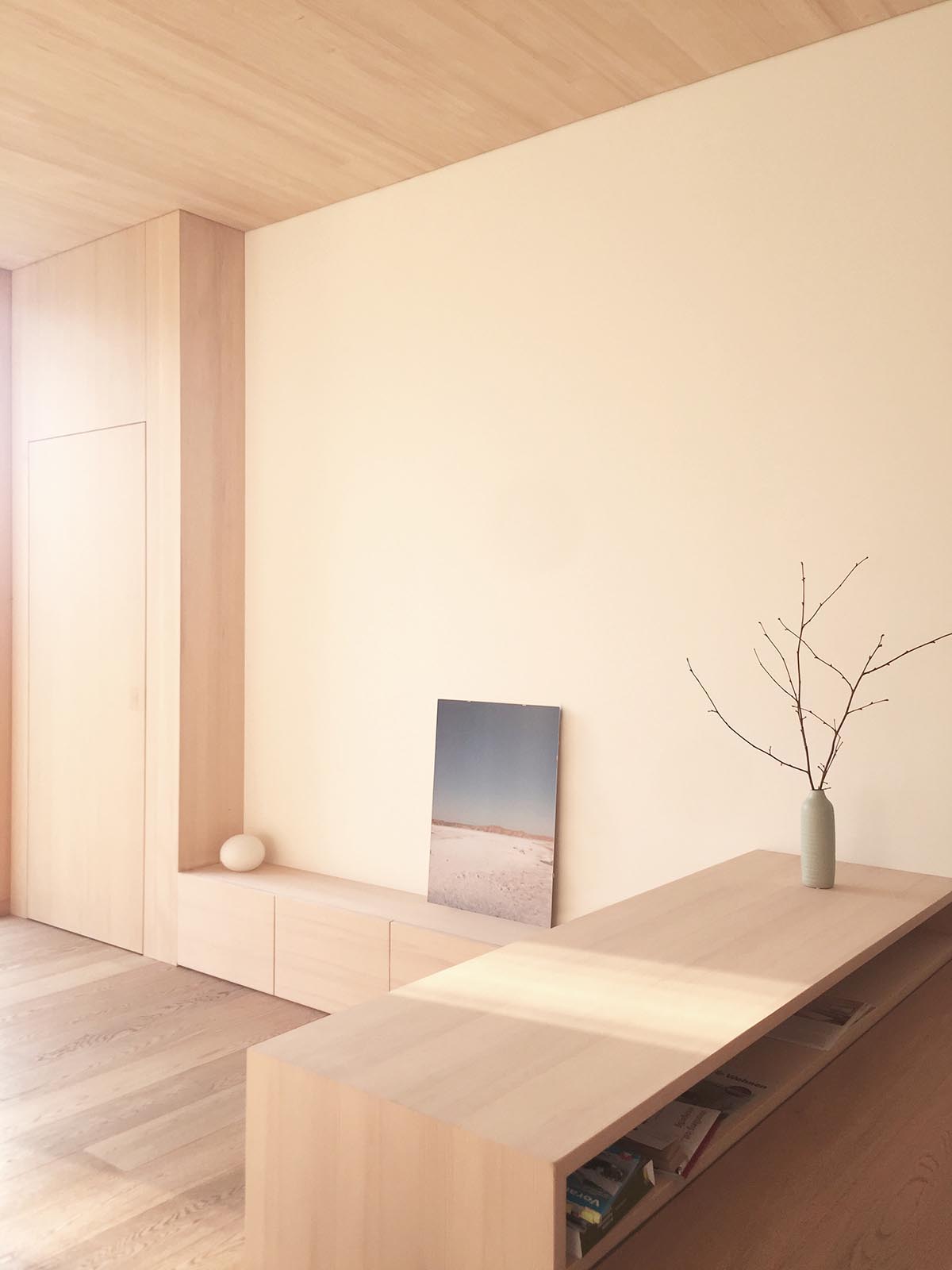 A modern interior with built-in wood shelves and cabinets.