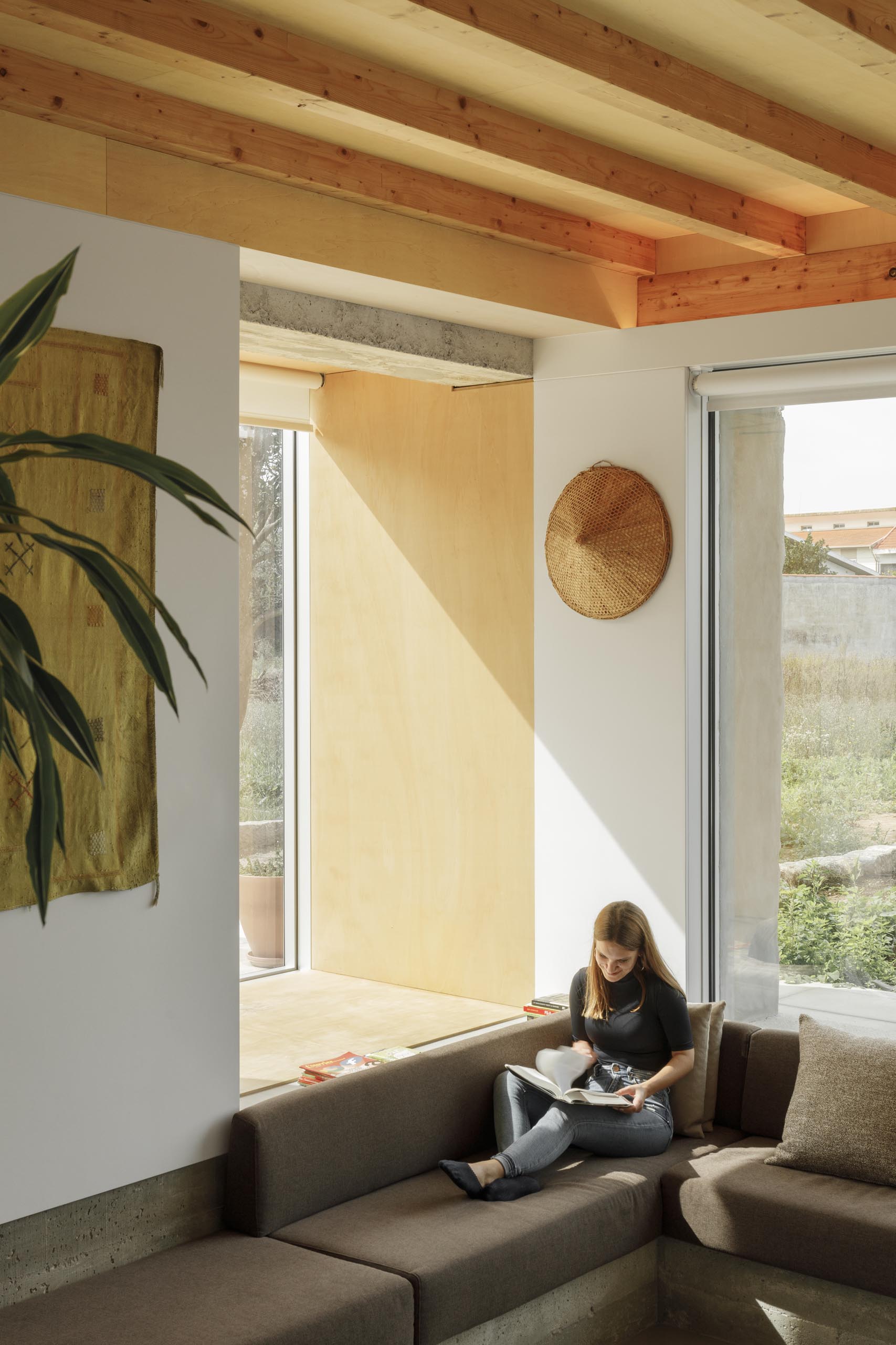 A sunken living room has a custom designed sofa.