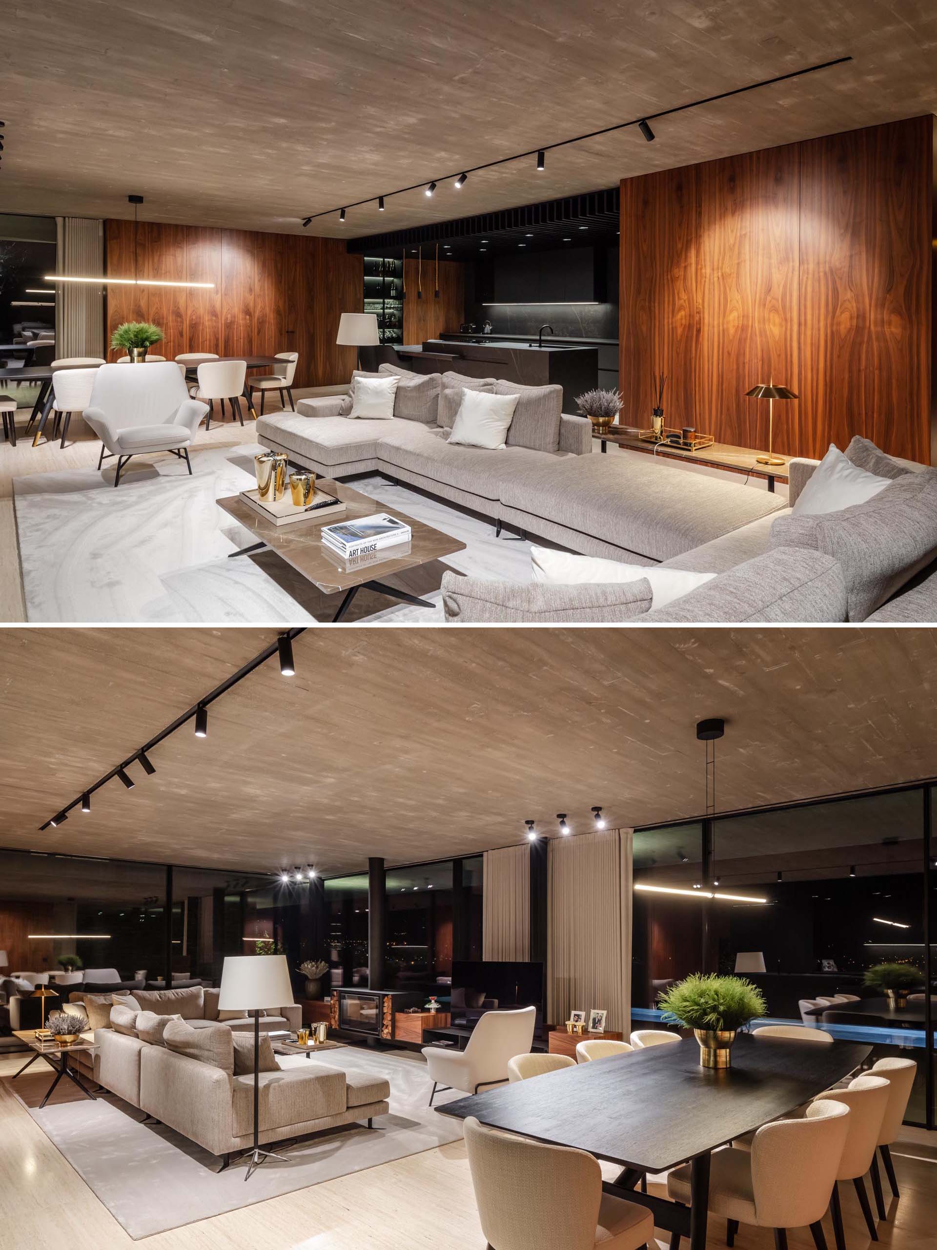 At night, the interior lighting in this modern home showcases the wood wall accents and other design elements, like the television and fireplace.