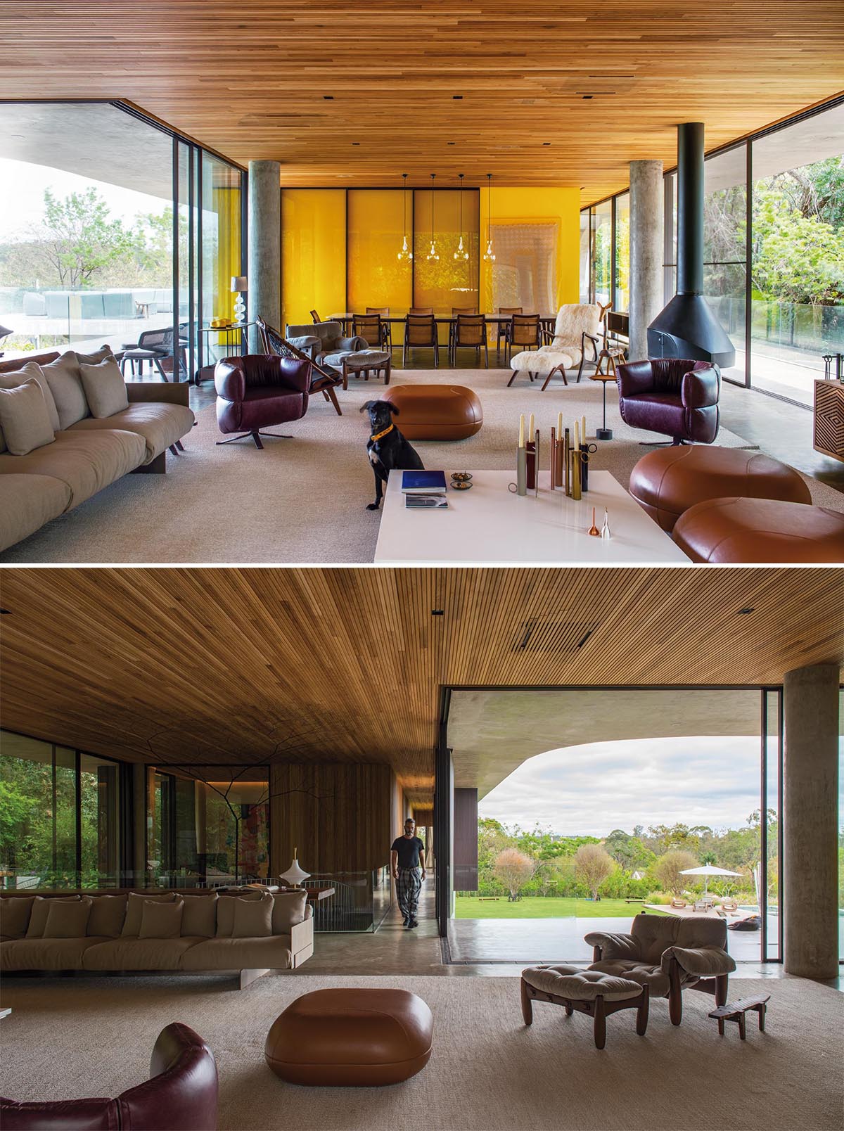 A wood ceiling and golden lighting adds a sense of warmth to this moderninterior, that also includes concrete floors, a hanging fireplace, and glass walls.