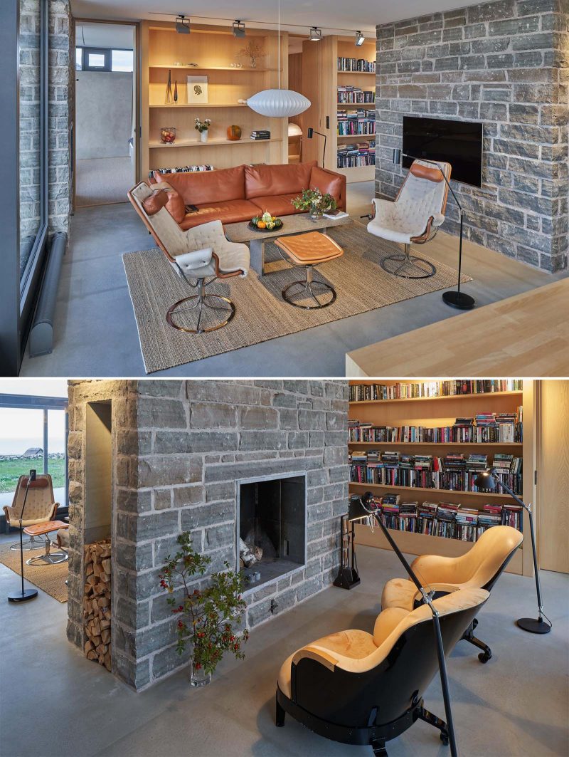 A limestone wall  separates the main living room from a small sitting area with a fireplace.