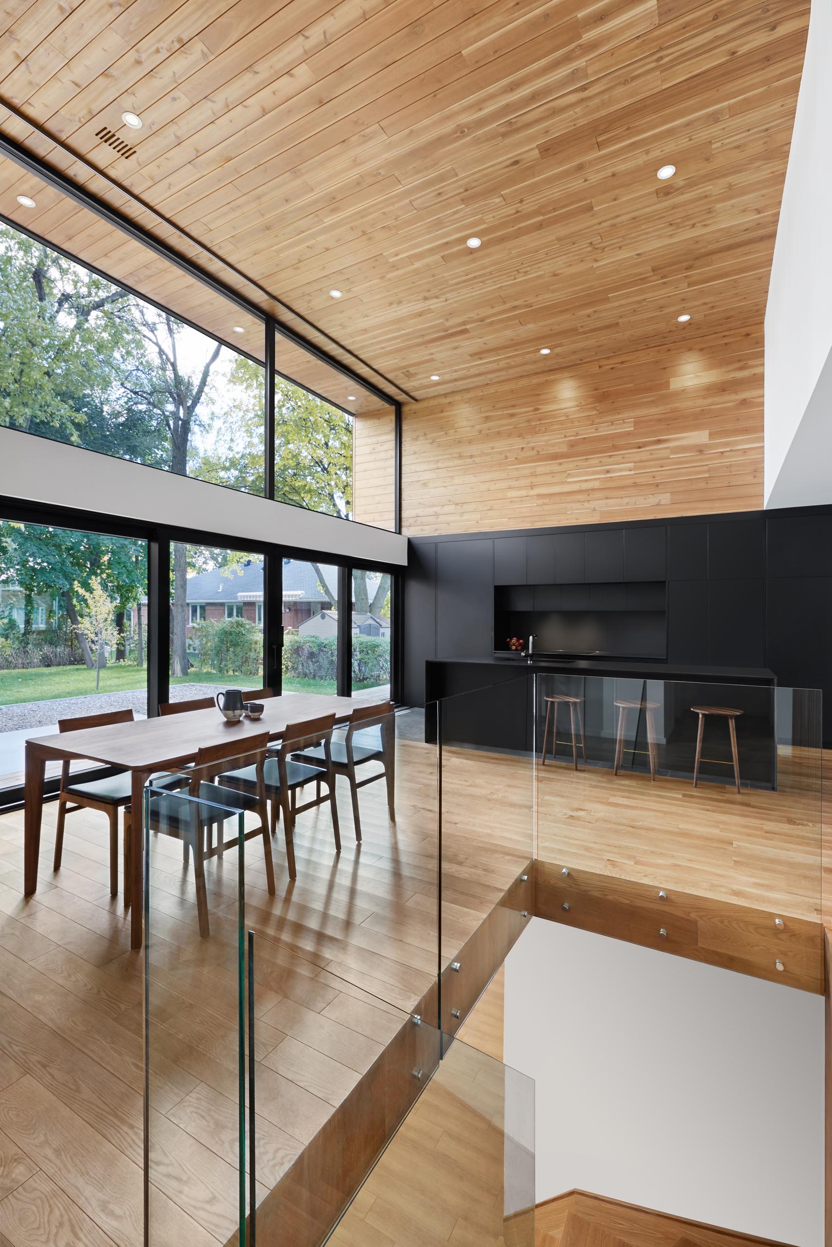 The minimalist hardware free cabinets in this modern matte black kitchen, have integrated appliances, creating the seamless look that was desired.