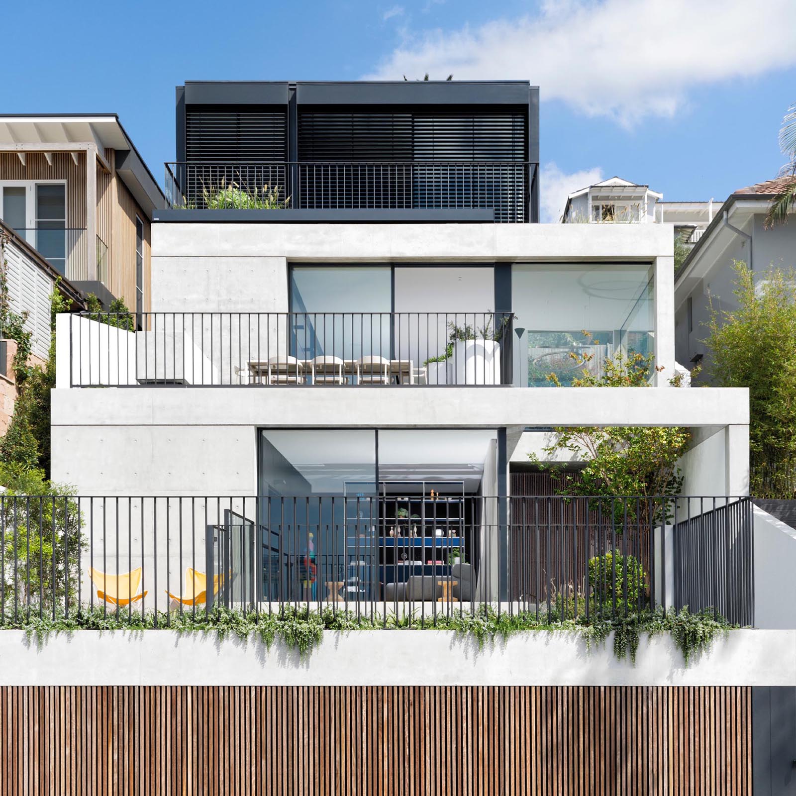 This Australian home is designed with a series of terraced floors that climb the steep block from the street.