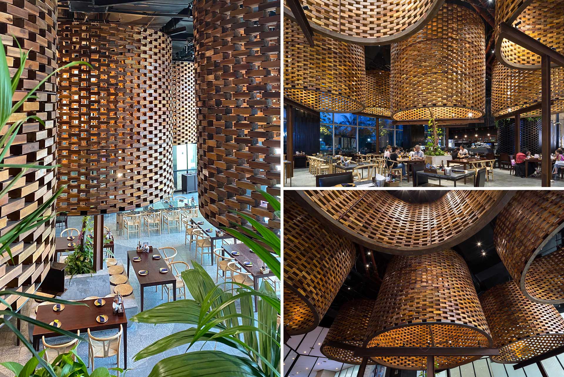 A modern restaurant with large sculptural cylinders made from wood bricks.