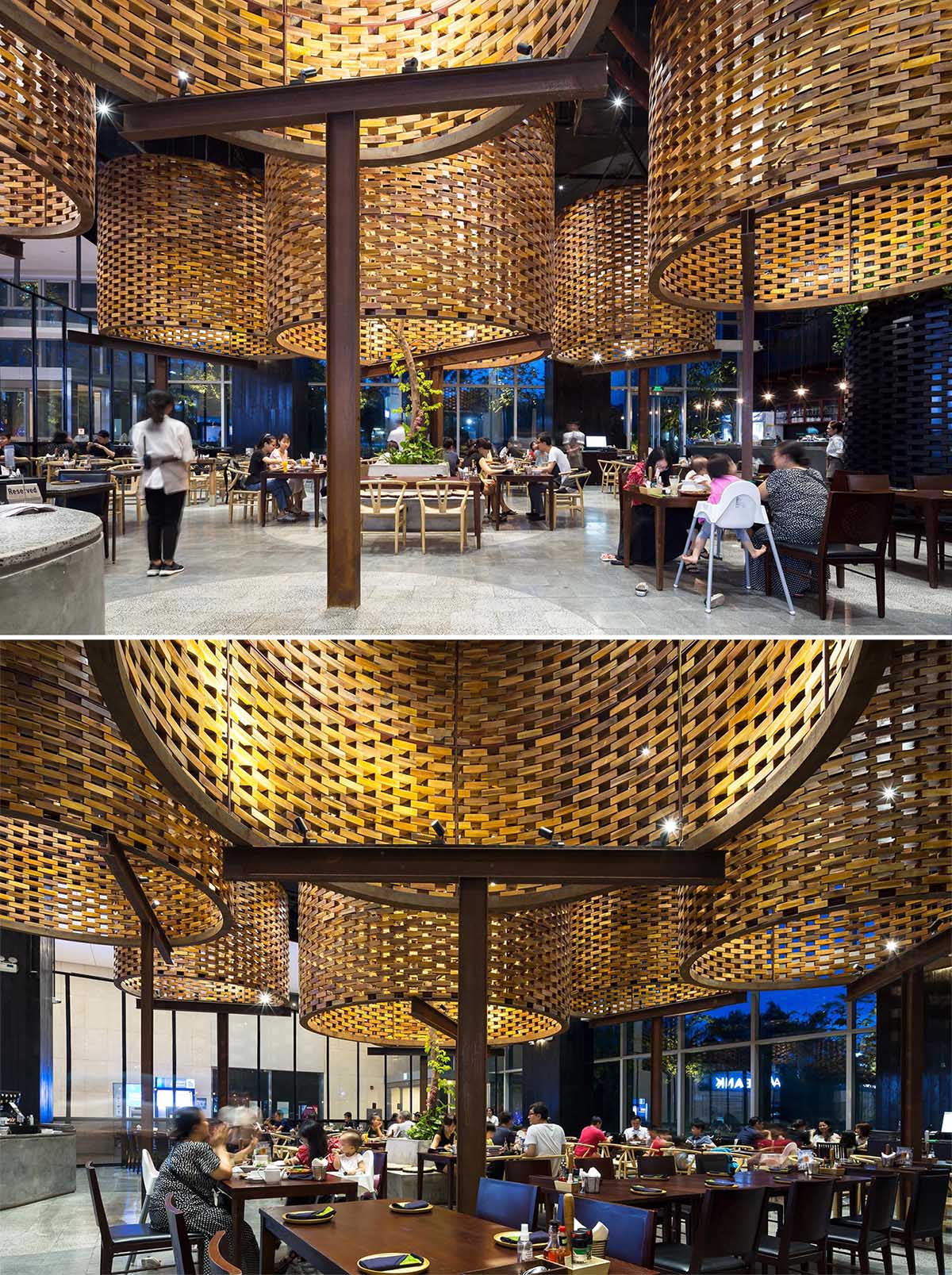 A modern restaurant interior with large sculptural cylinders made from wood bricks.