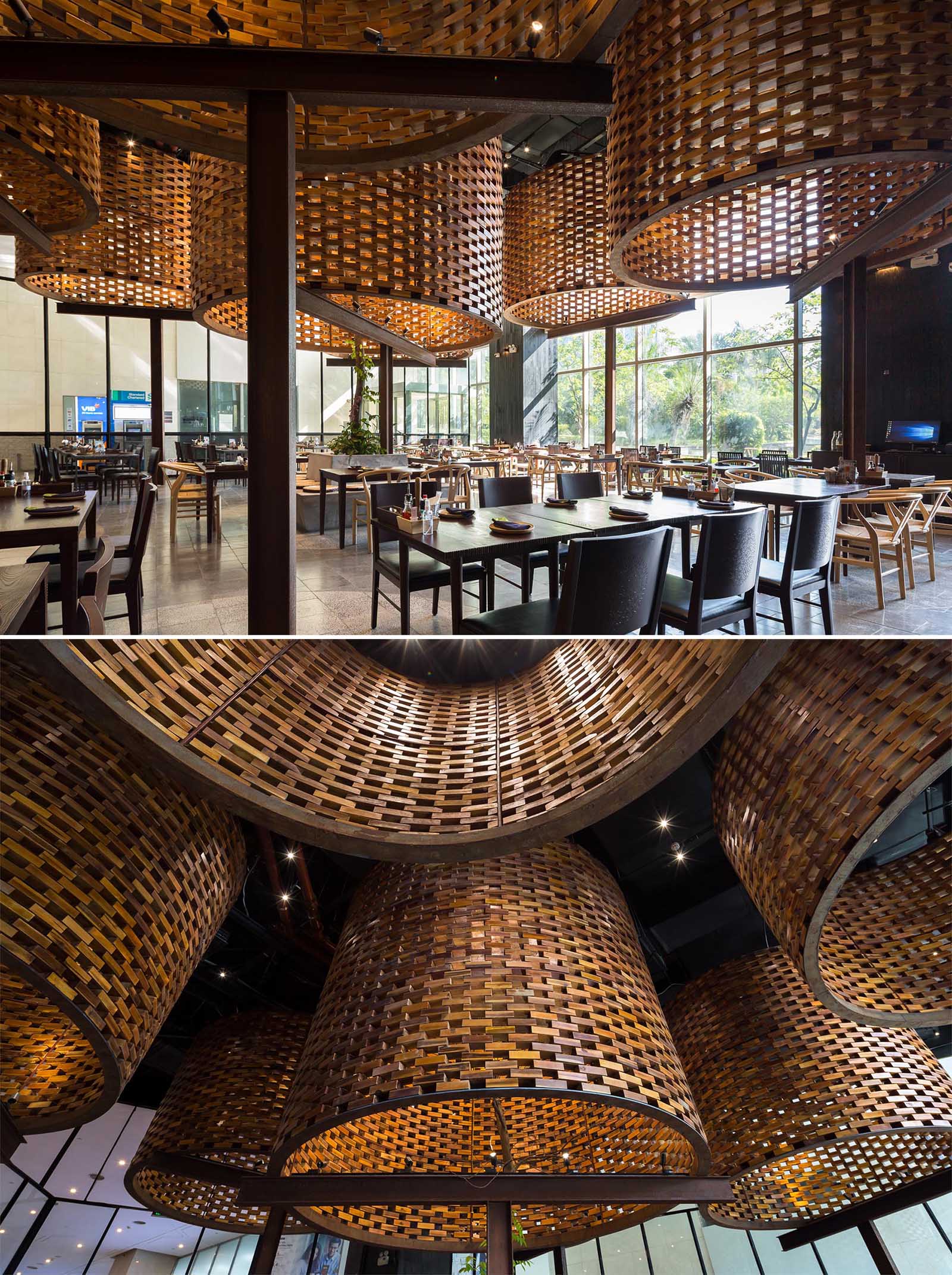 A modern restaurant with large sculptural cylinders made from wood bricks.