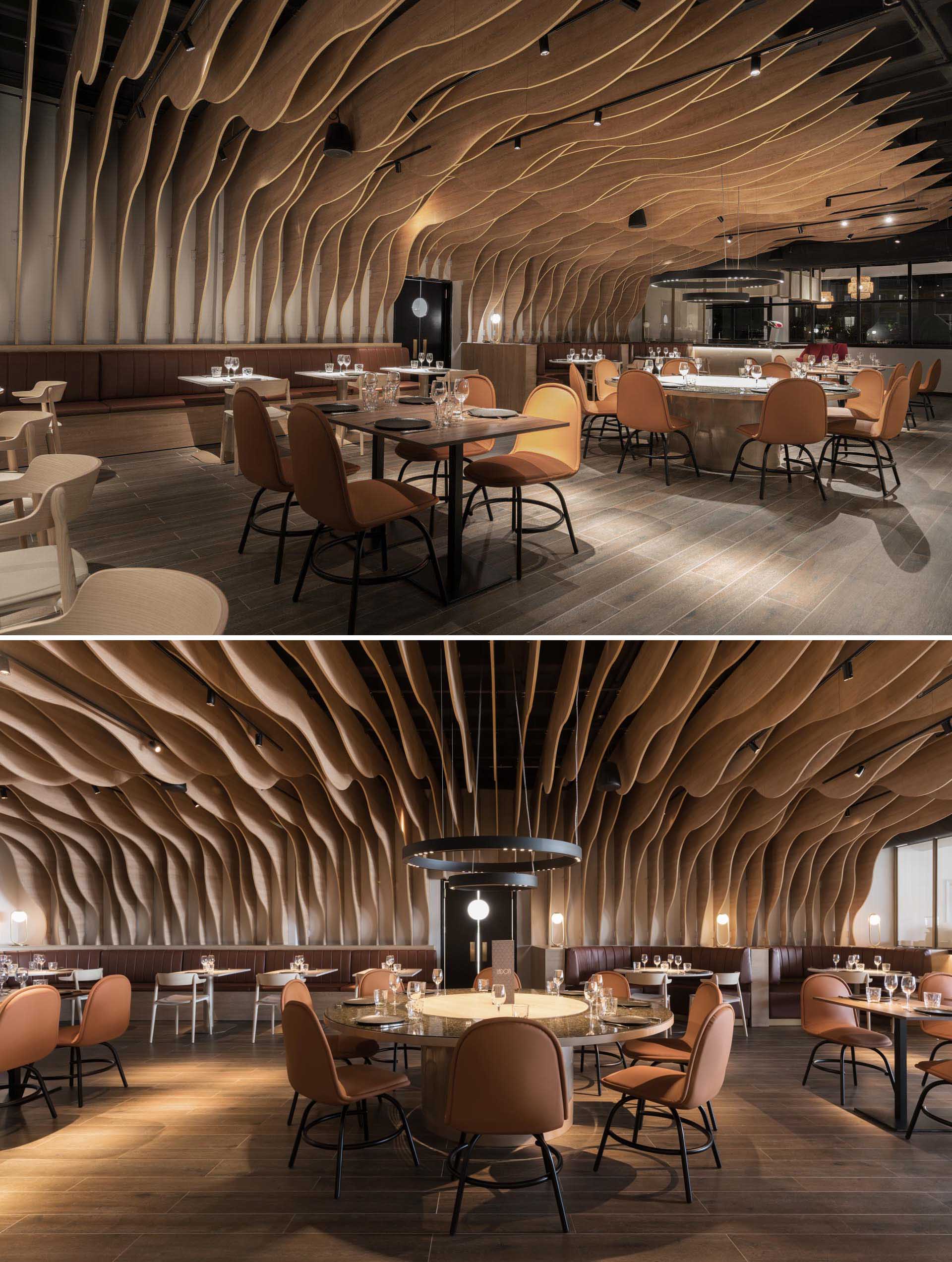 A modern restaurant with sculptural wood fins that cover the walls and ceiling.