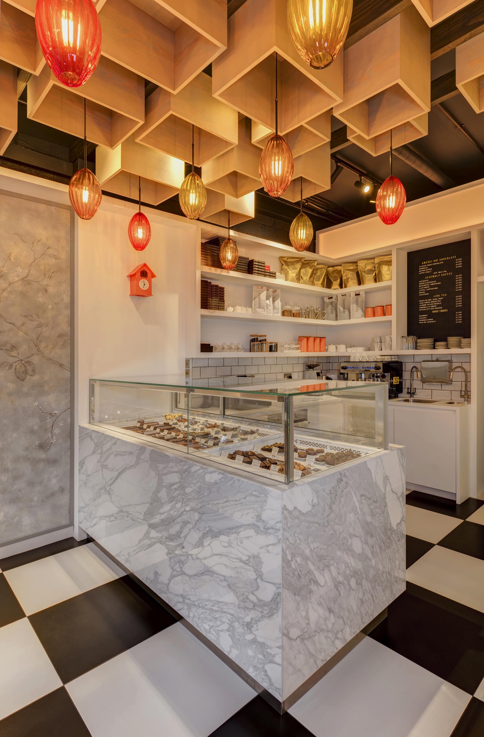 Central to this retail interior is a bespoke Calacatta marble clad climate controlled display cabinet that used for displaying individual chocolates and patisserie.