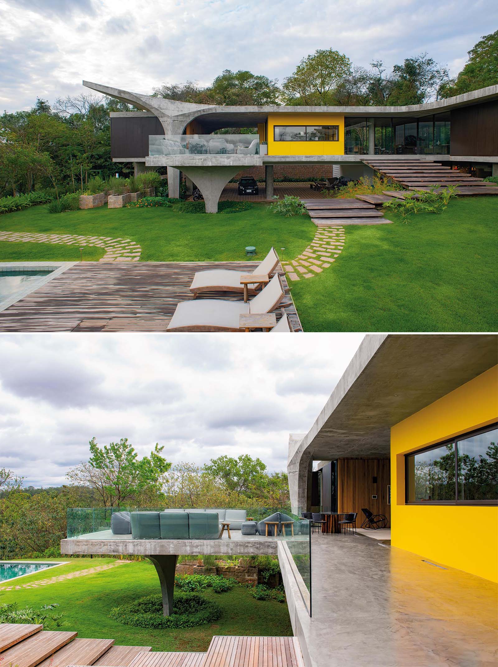 The main level of this modern home opens to an expansive concrete balcony, with wood stairs that lead down to the outdoor areas.