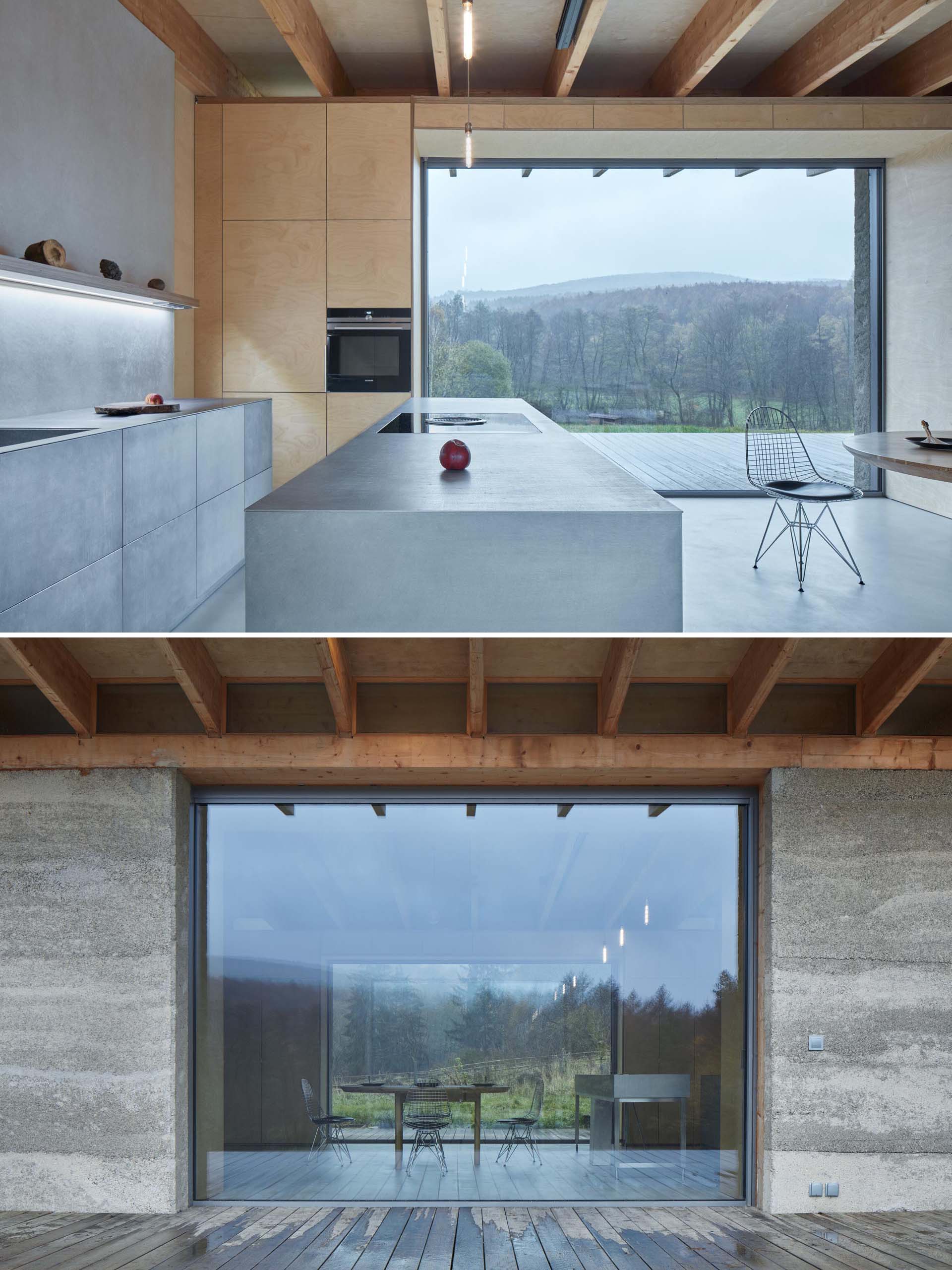 A modern cabin with a stainless steel kitchen and plywood walls.