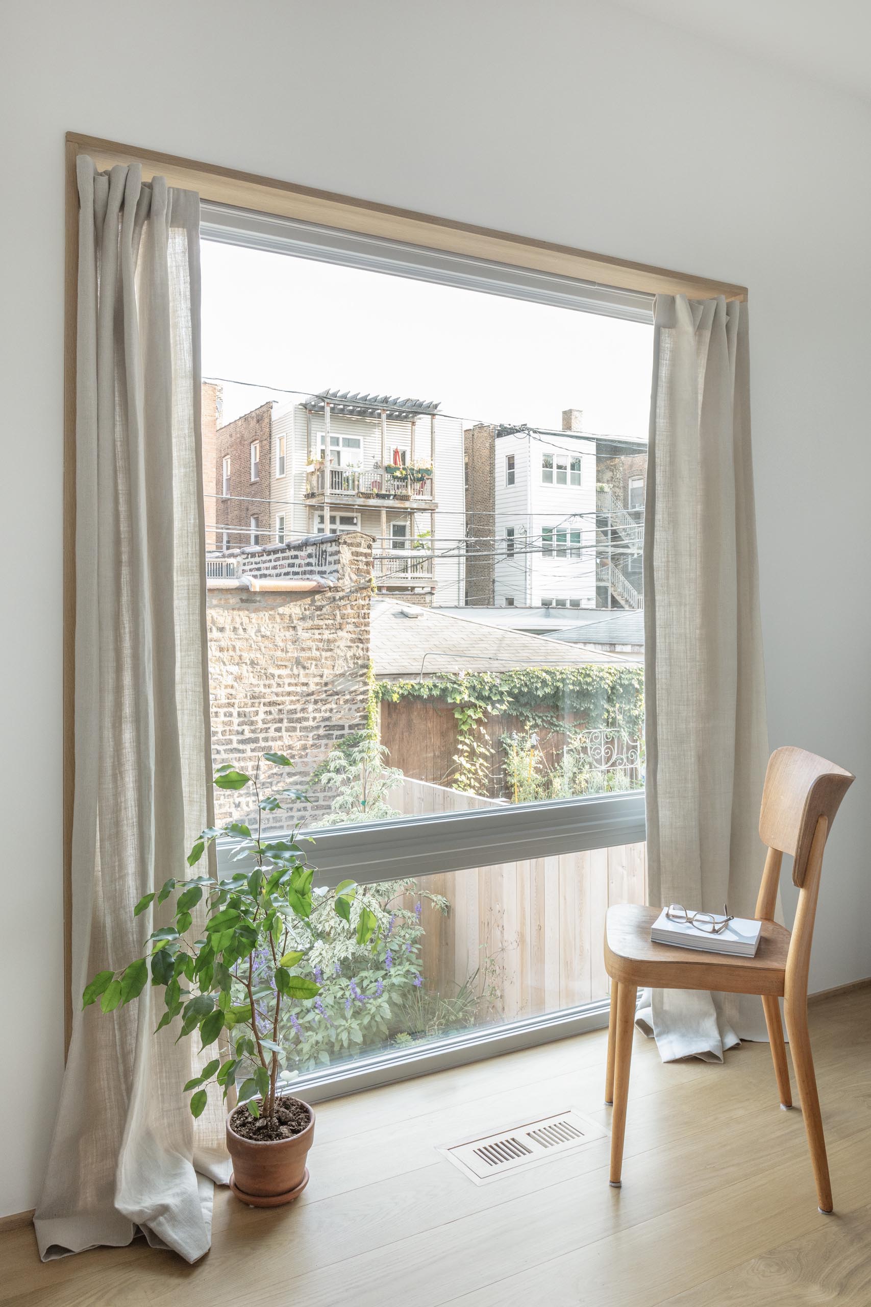 A modern white home interior with wood window frames.