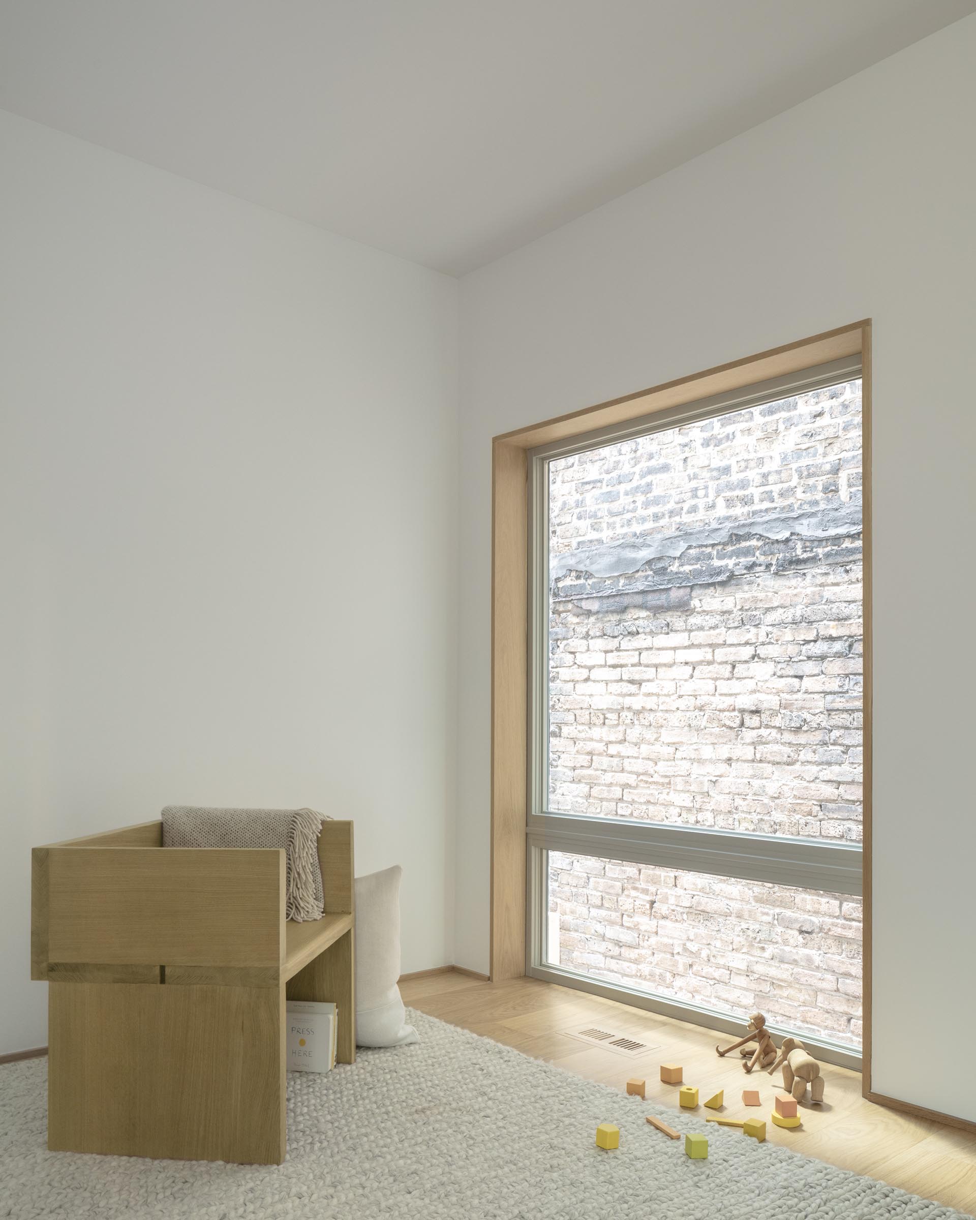 A modern white home interior with wood window frames.