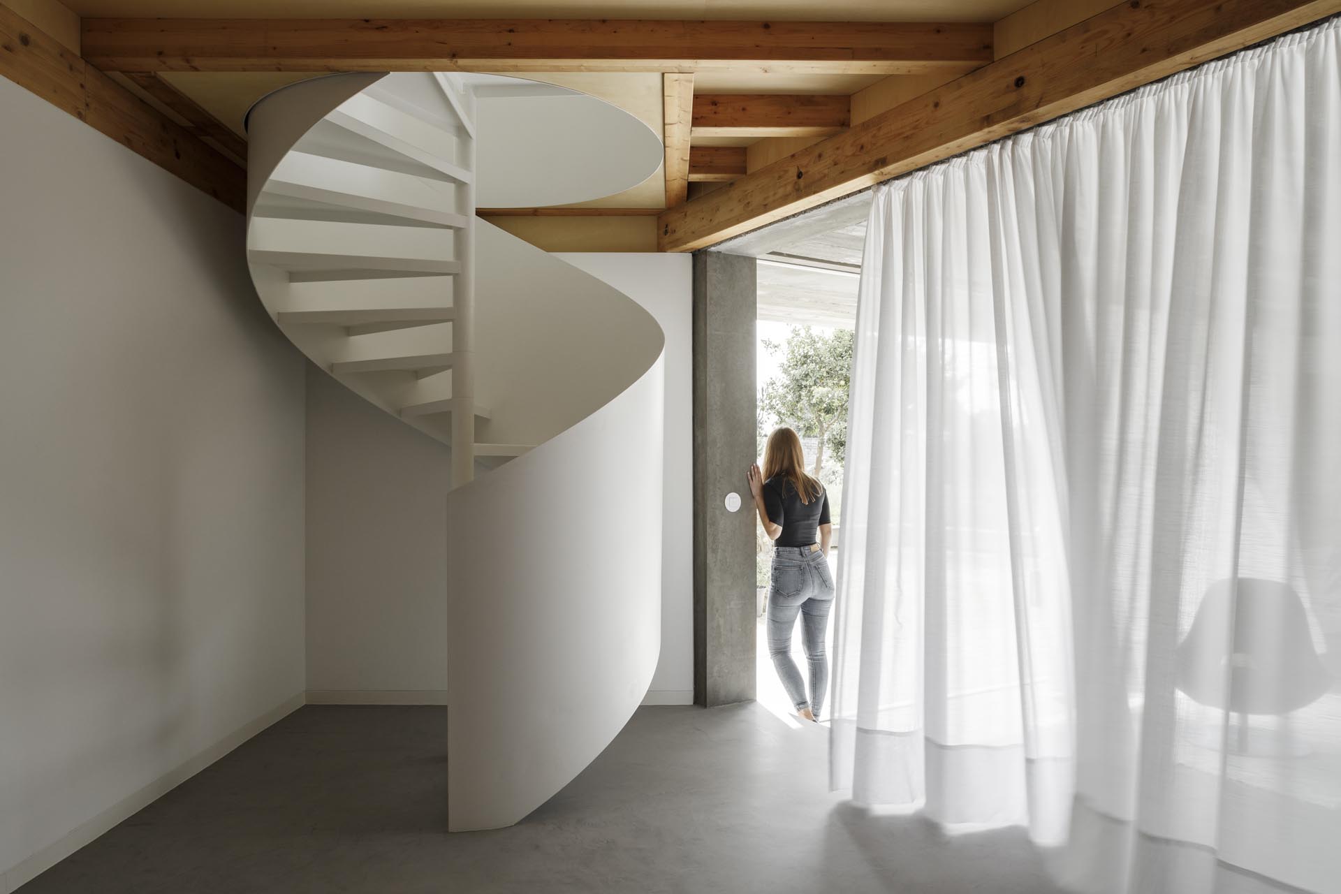 A modern home with a white spiral staircase.