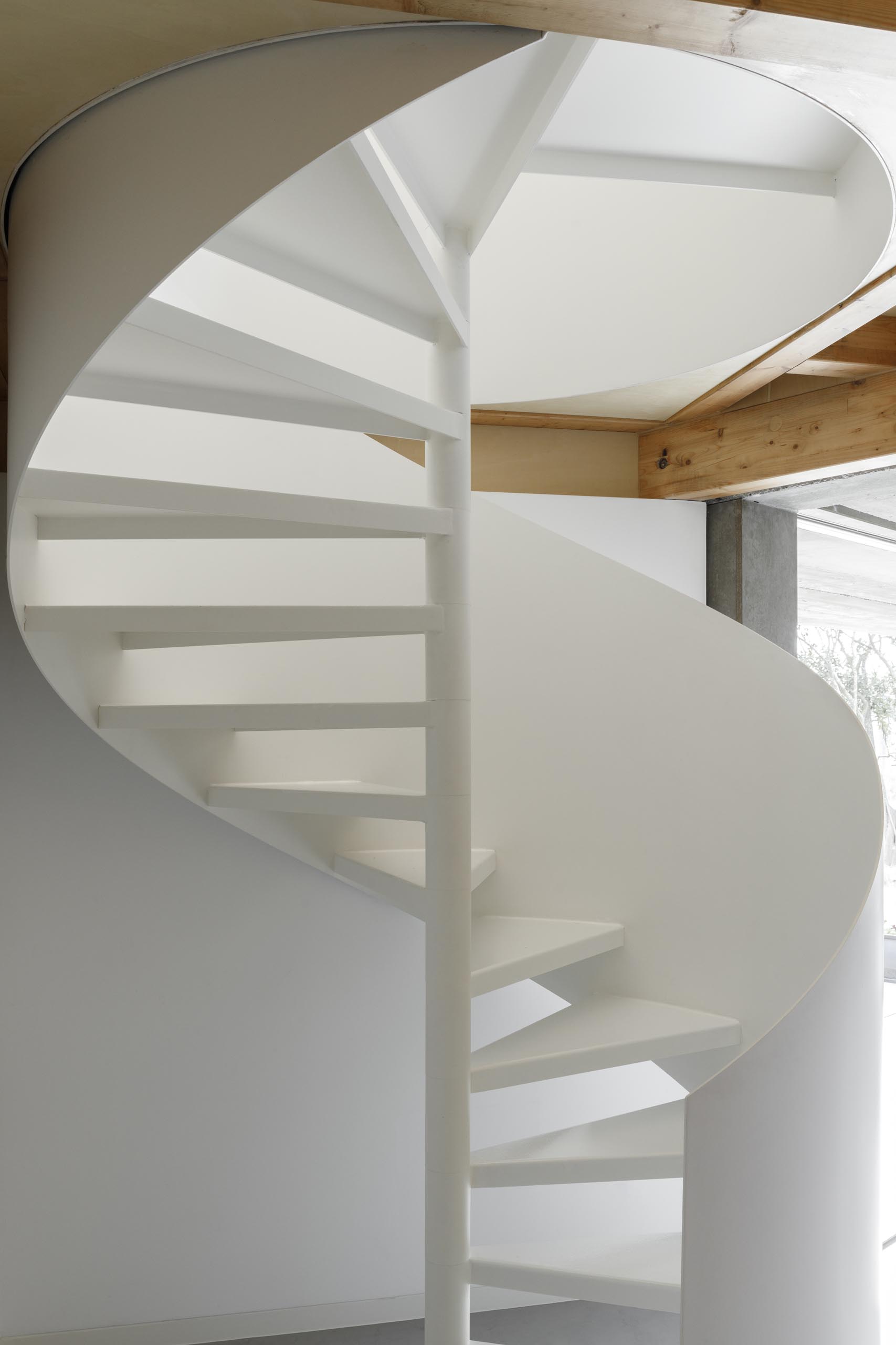 A modern home with a white spiral staircase.