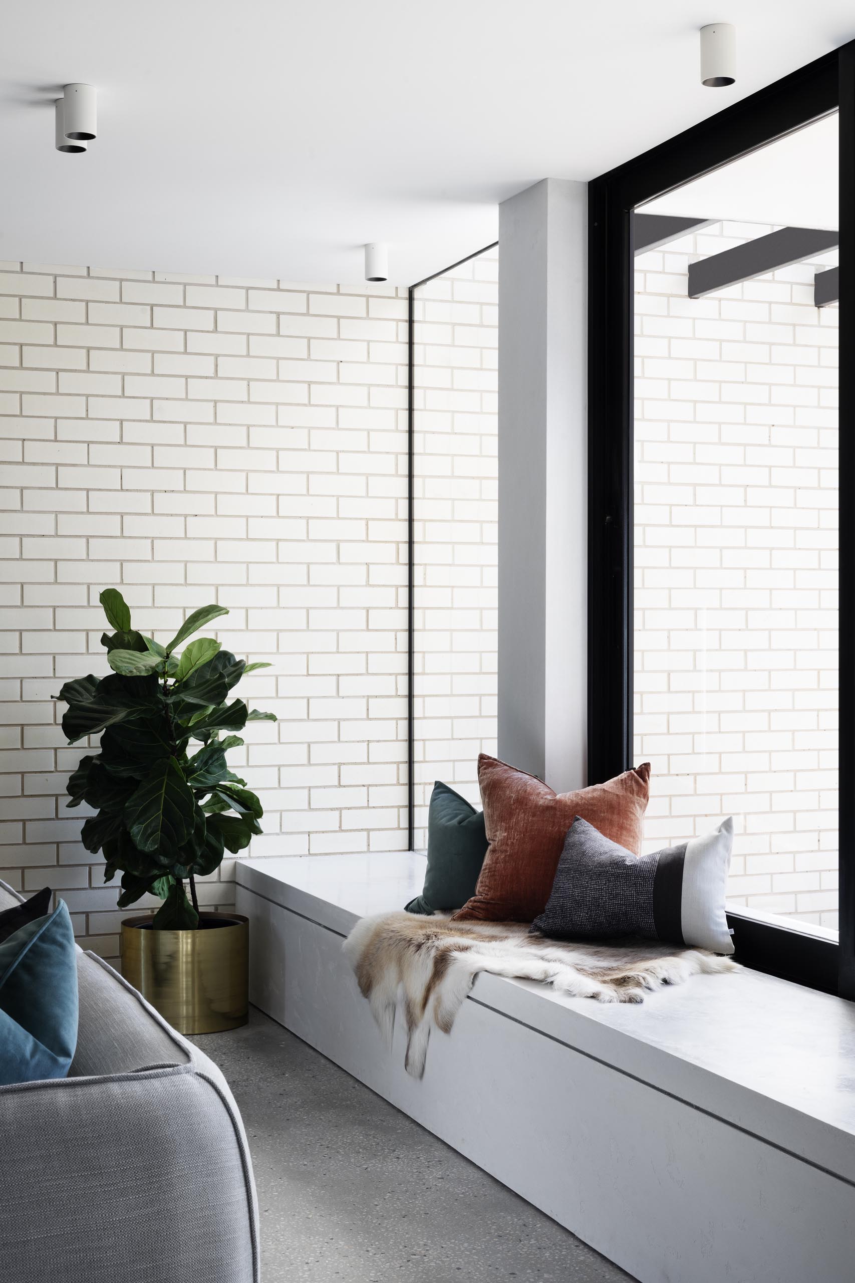 A modern home interior with a built-in white window bench.