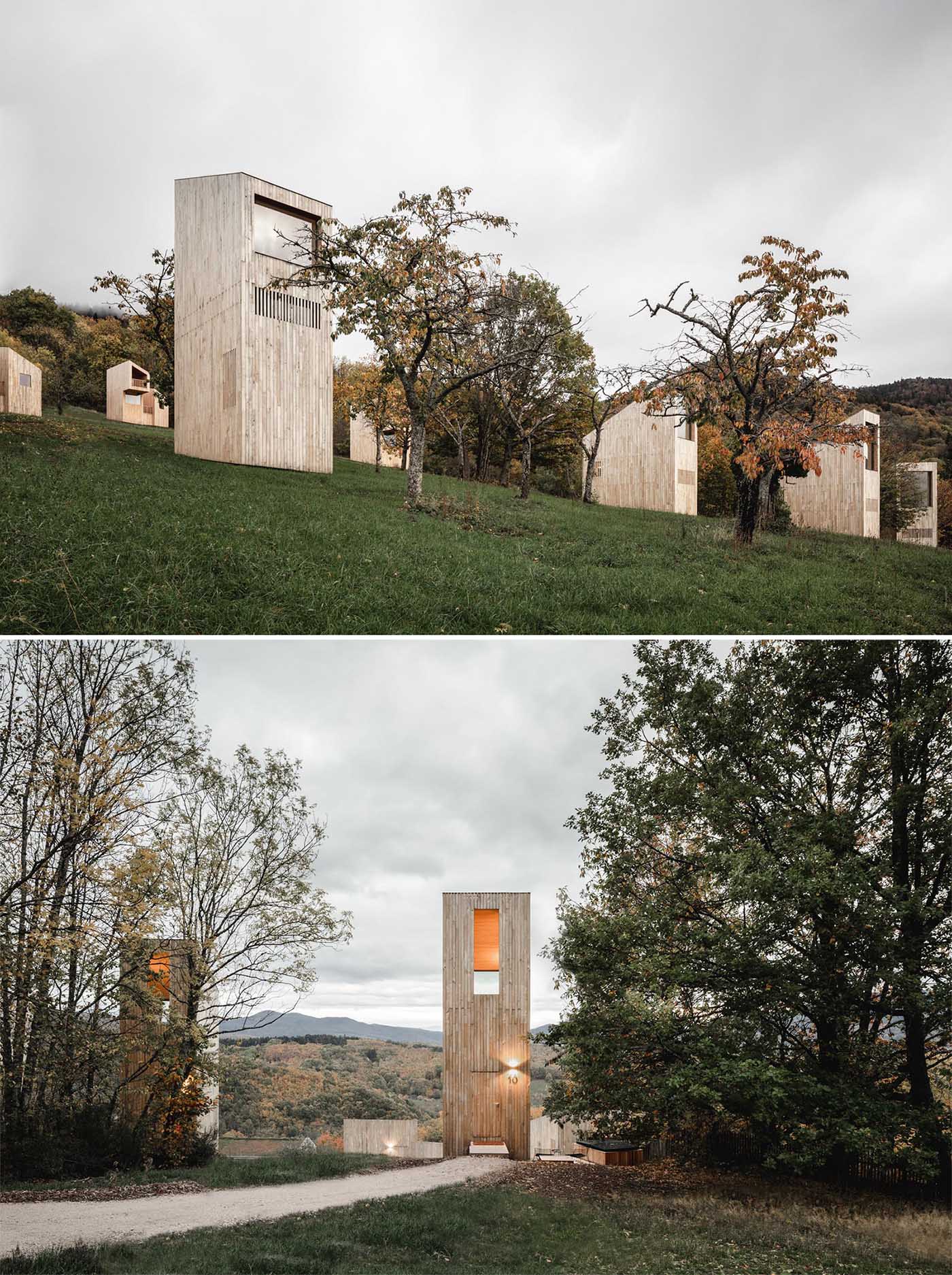 Modern cabins with a vertical design, light wood exterior, and large windows.