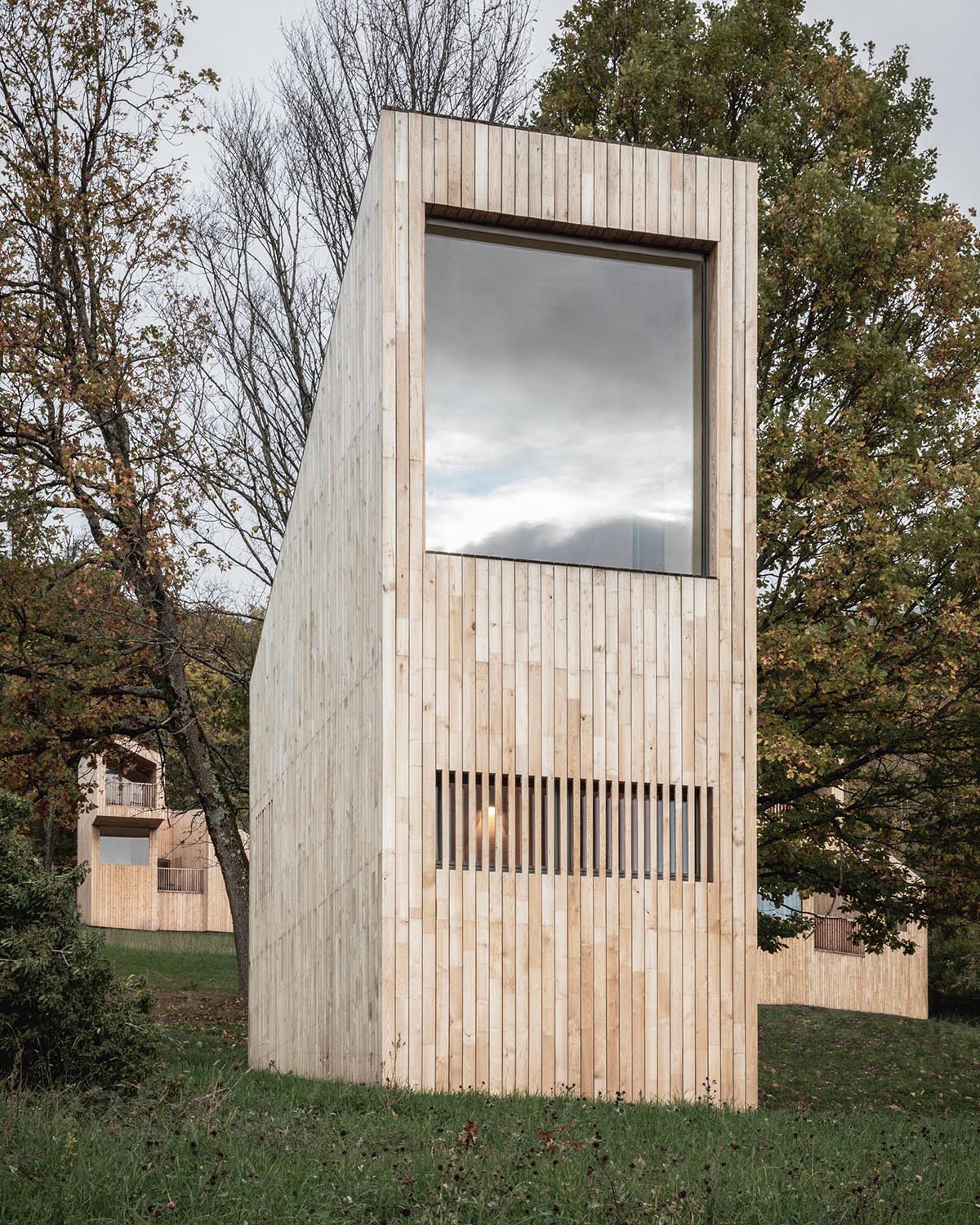 A collection of small wood cabins designed as part of a hotel in France.