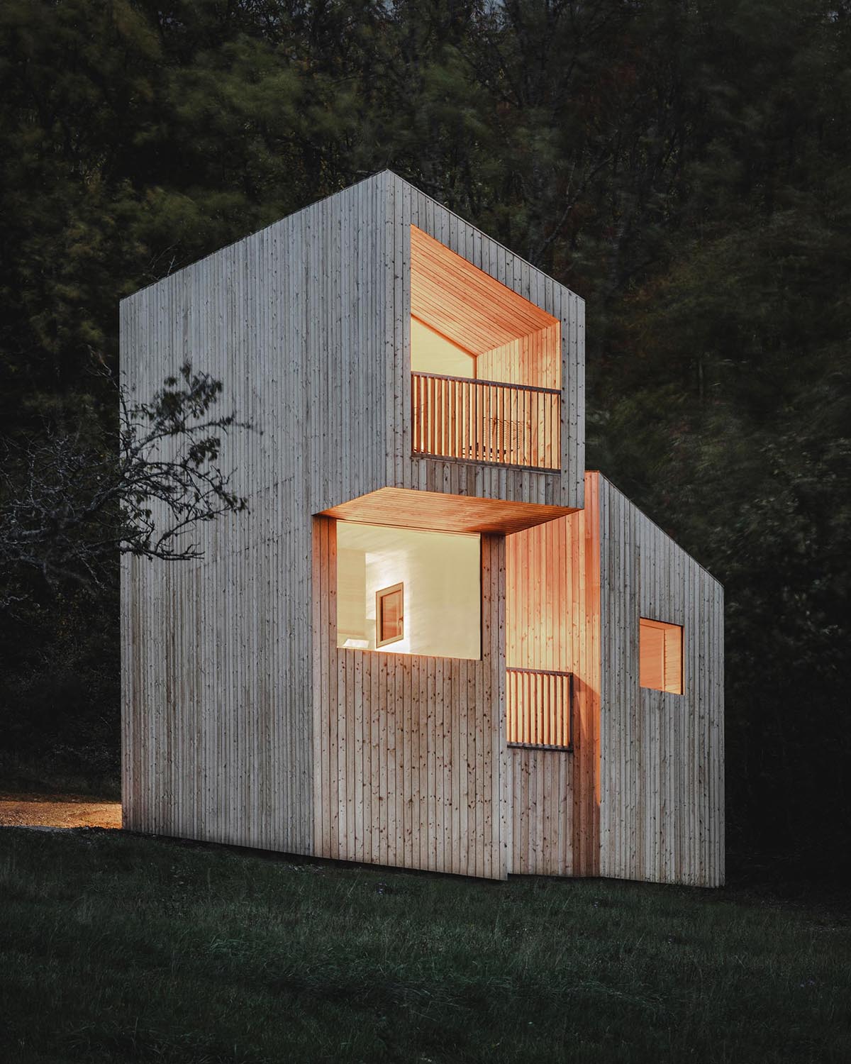 A small wood cabin with light wood exterior.