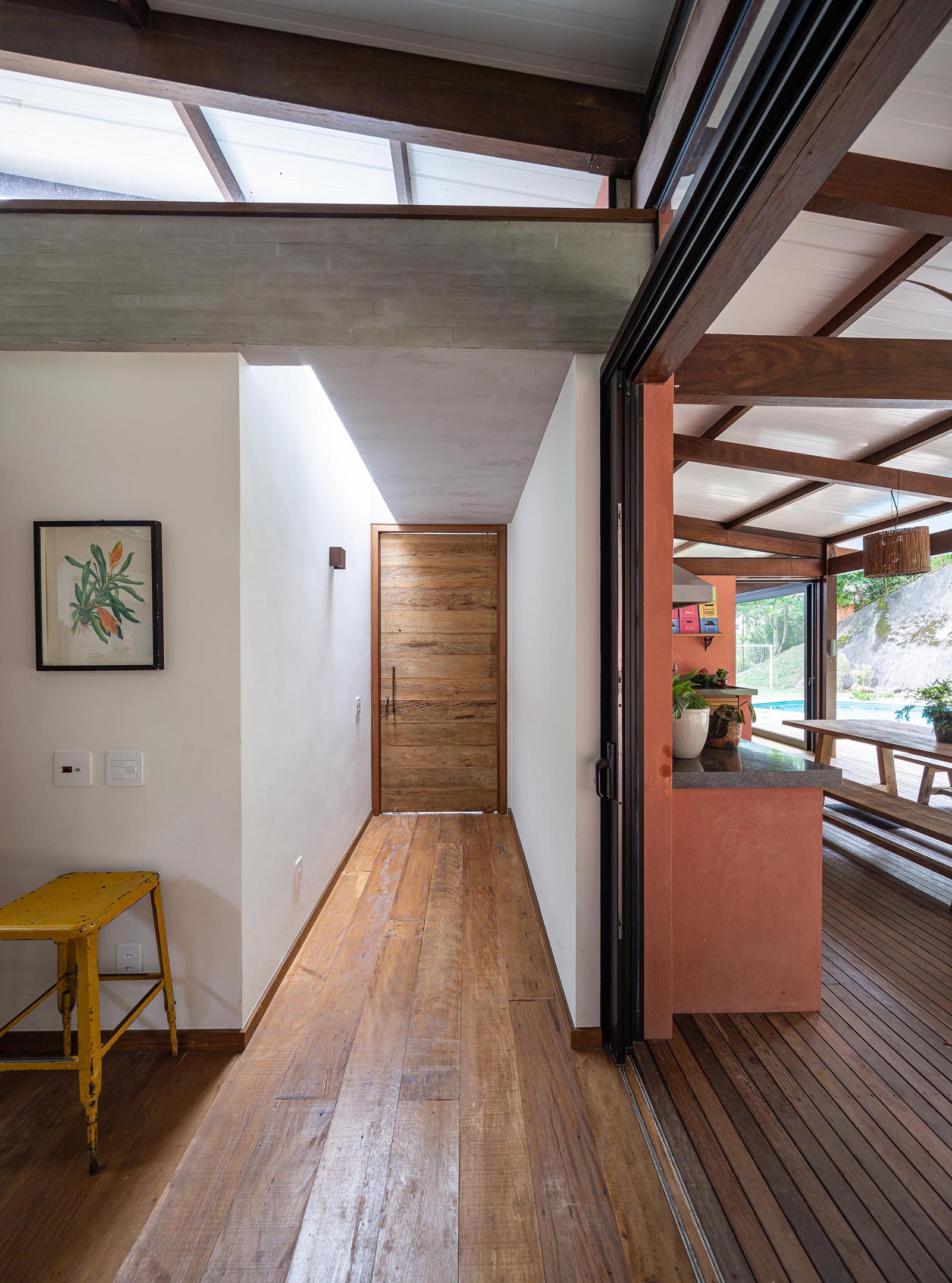 Sliding doors in the main room of this modern house open completely and are used to create an indoor/outdoor living environment.