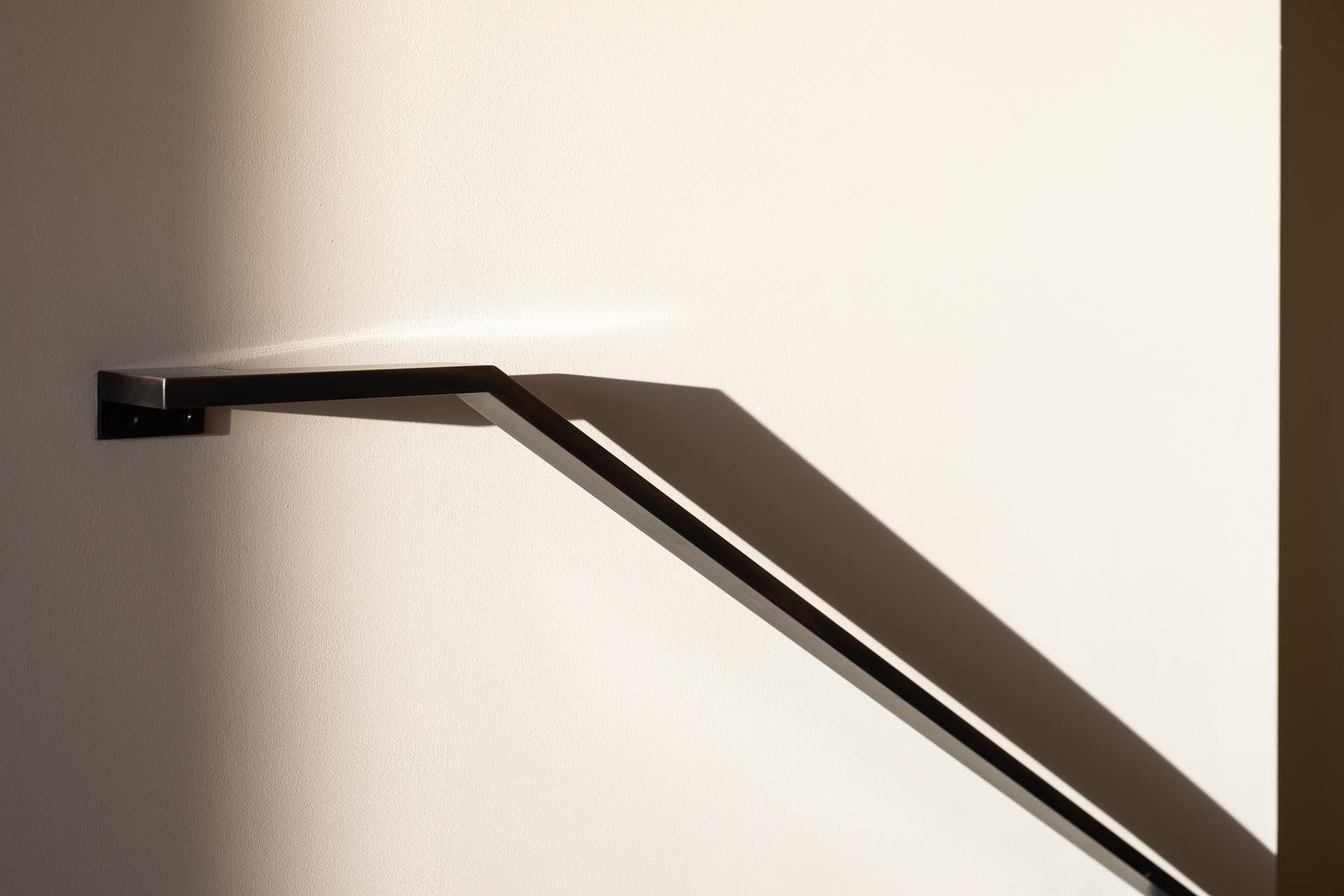 A modern metal stair handrail.