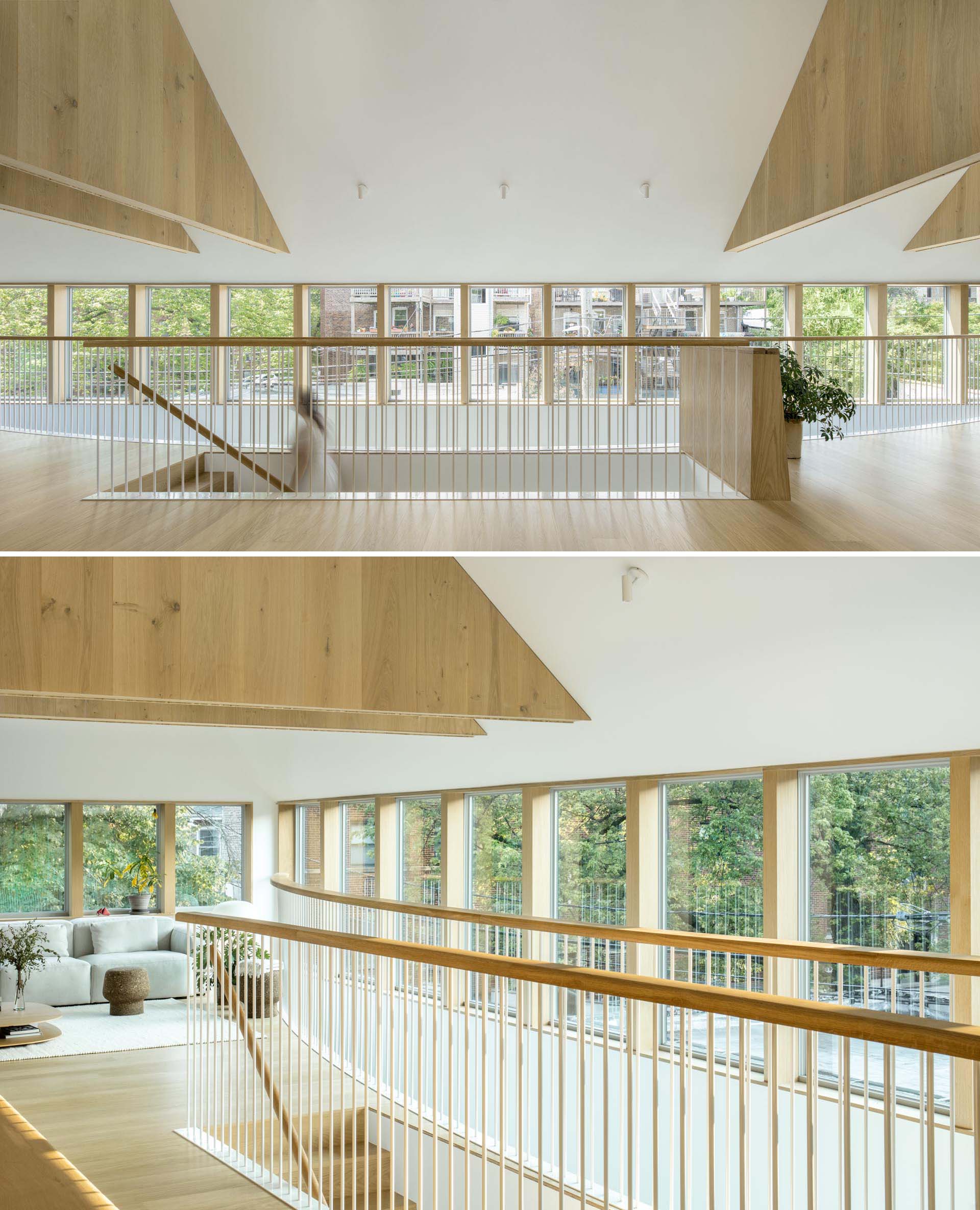 Wood stairs with a matching handrail and railing lead up to the social areas of this modern home.