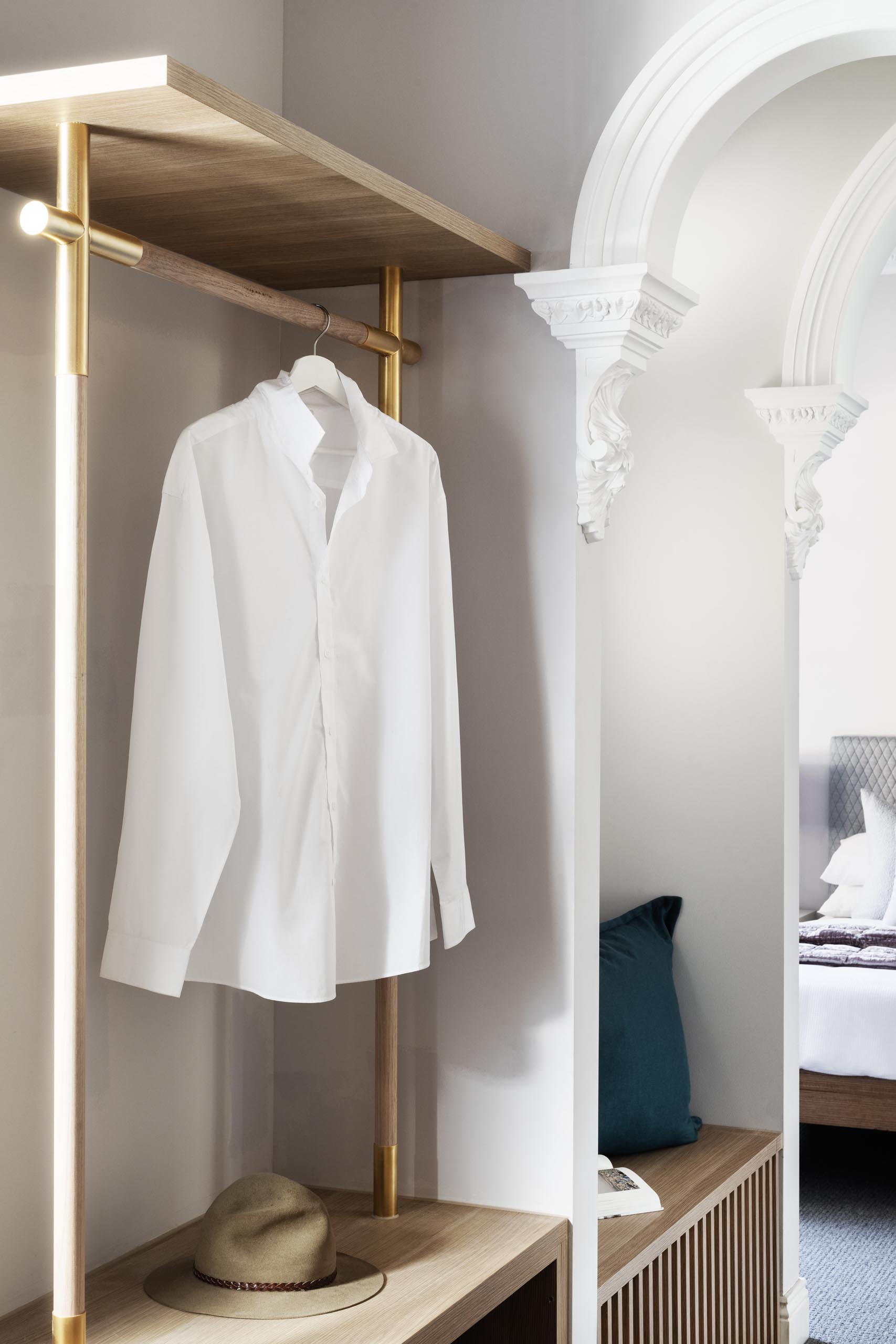 An open closet and a built-in bench in a remodeled heritage house.