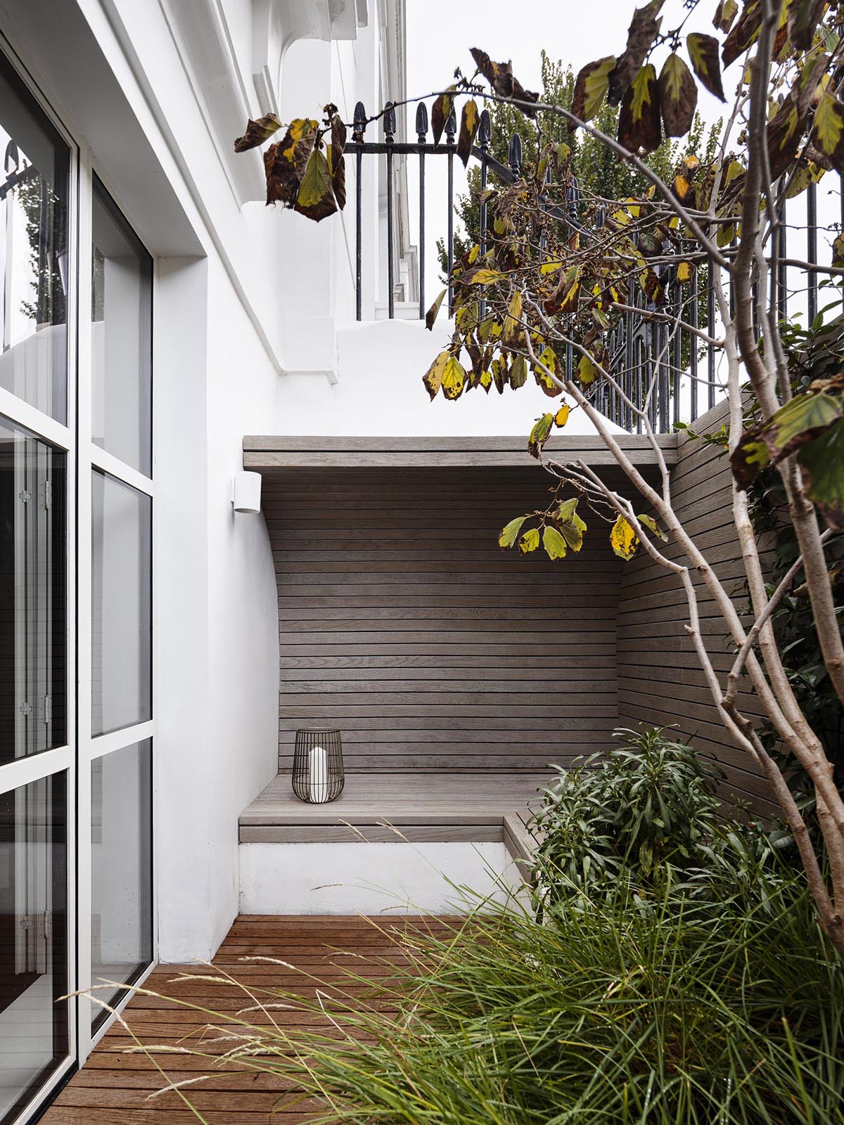 A patio with a built-in bench.