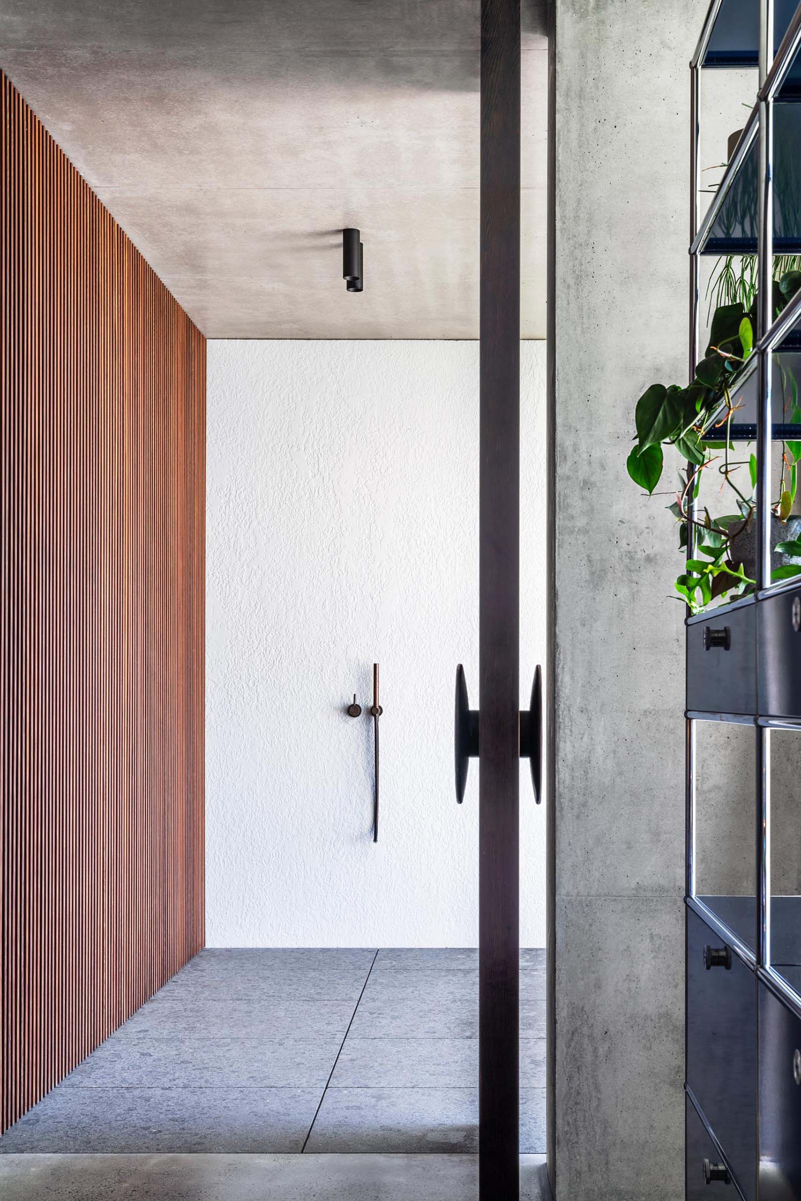 An oversized pivoting wood front door.