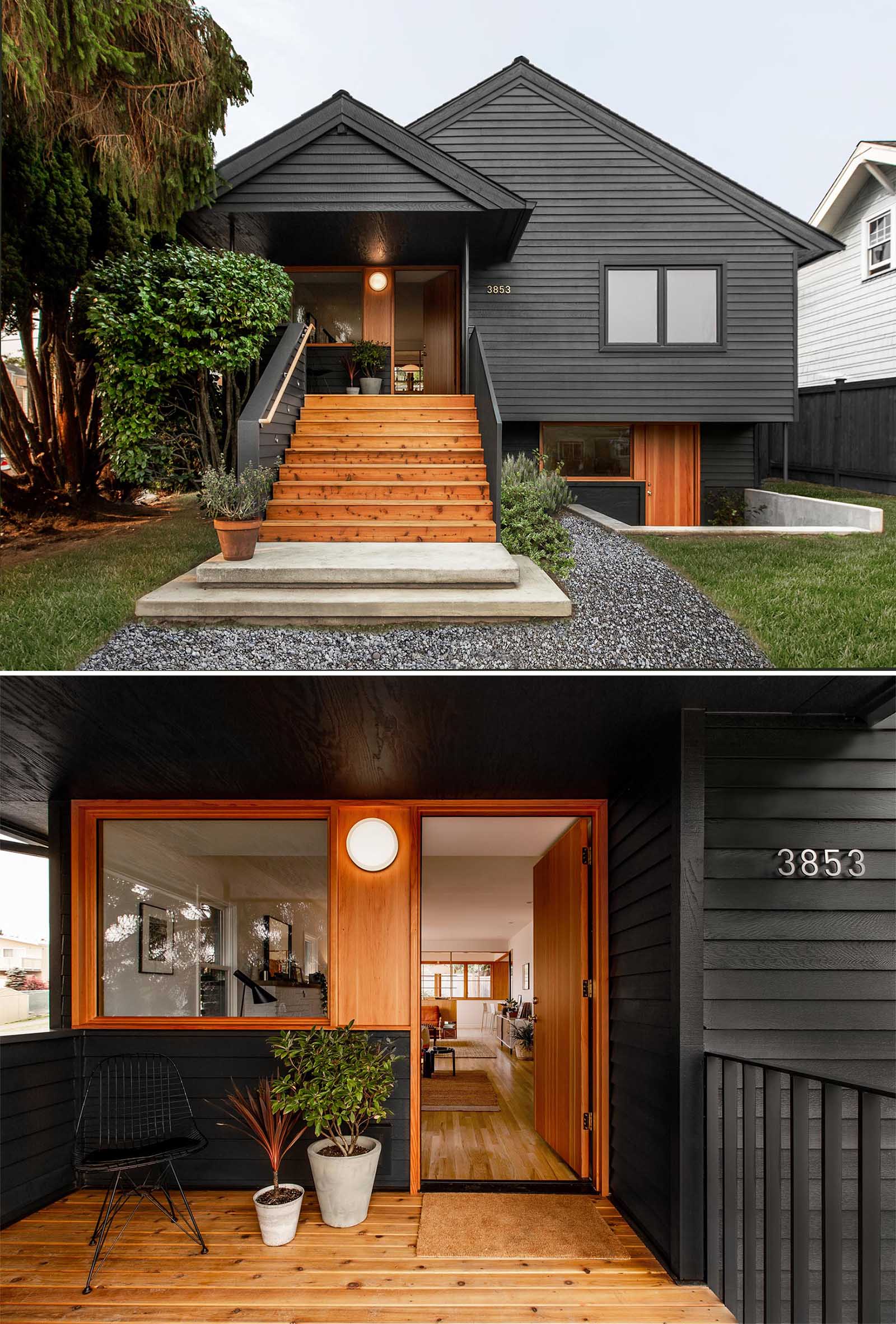 A remodeled 1920s bungalow received an updated black exterior, wider wood stairs that lead up to the front porch, as well as a secondary lower entrance that can be used to access a home office, guest quarters, or secondary living unit.