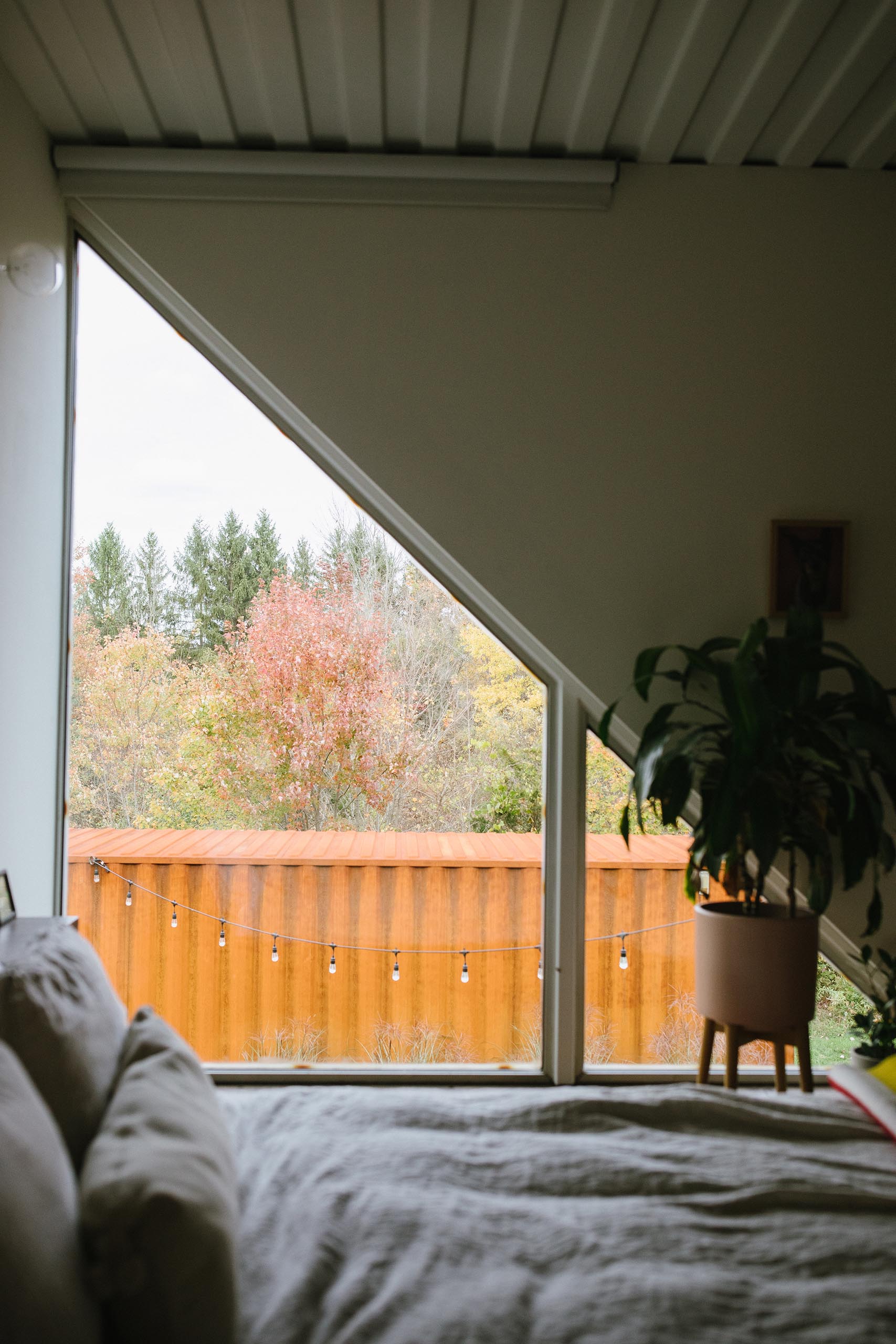 A modern shipping container home with angled windows.