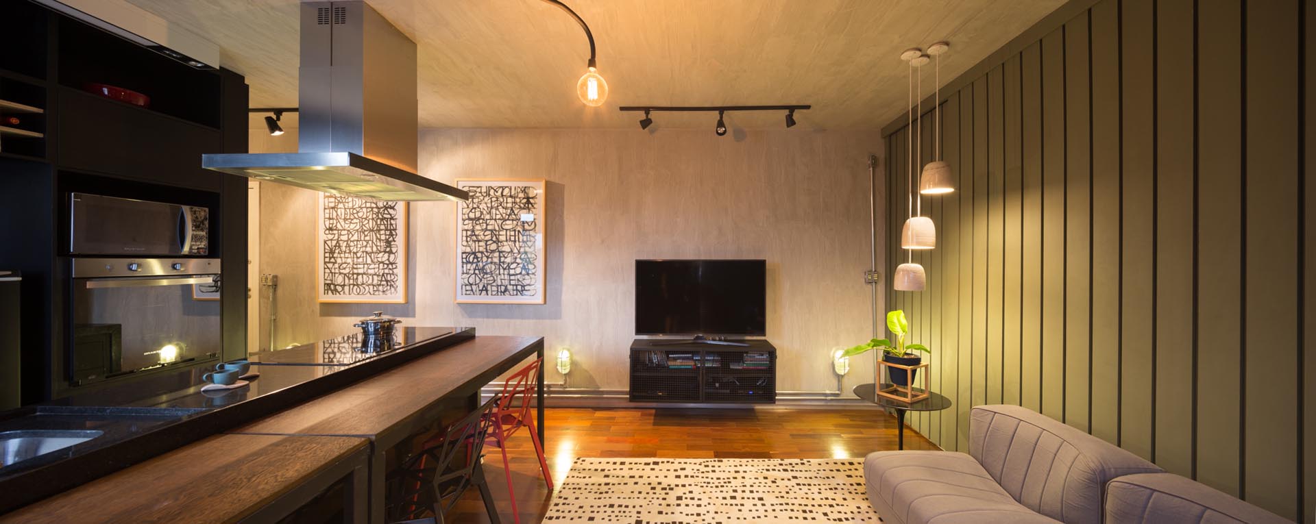 A modern living room with a muted green accent wall made from panels of MDF.