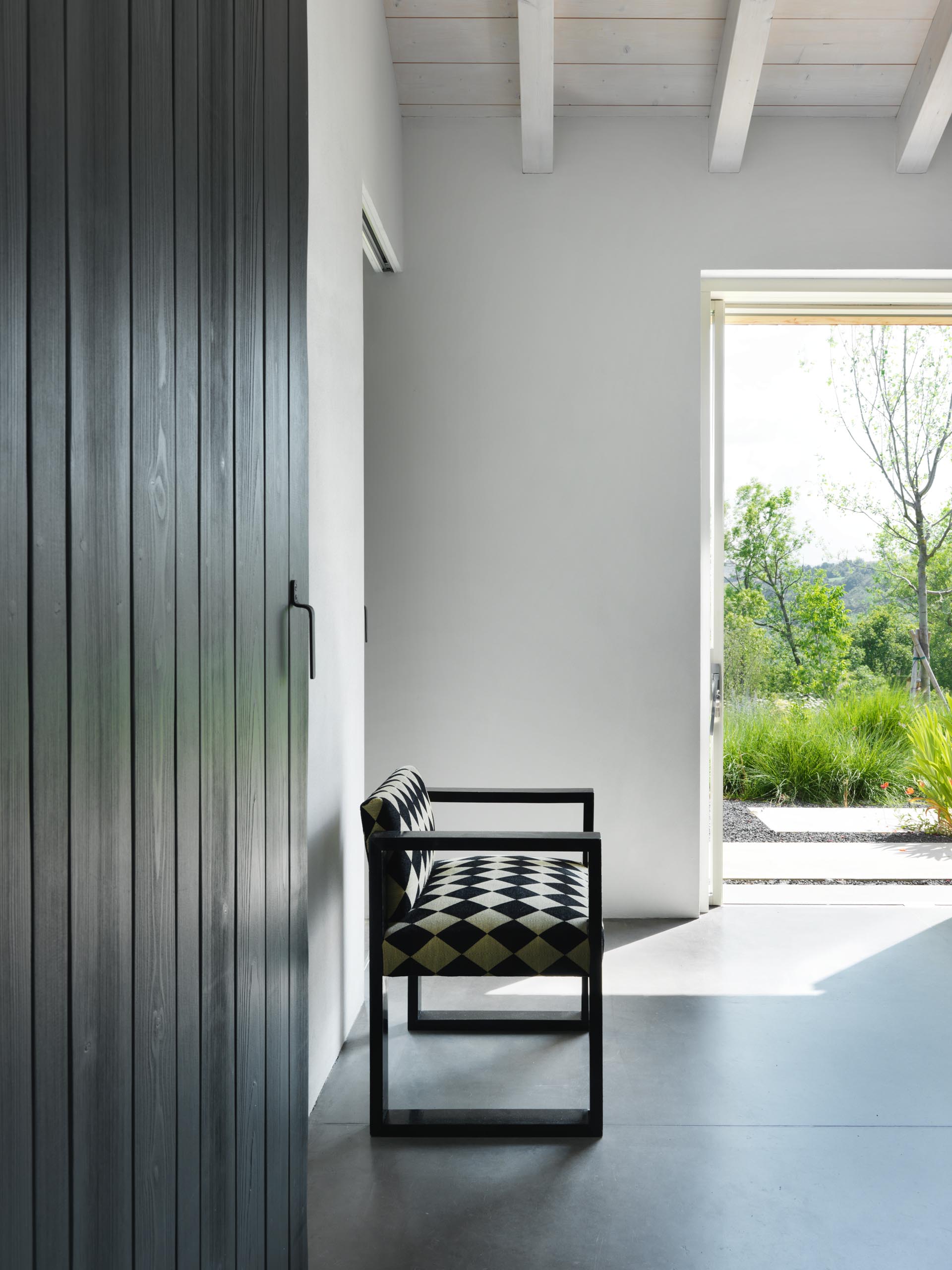 A modern black wood bedroom door.