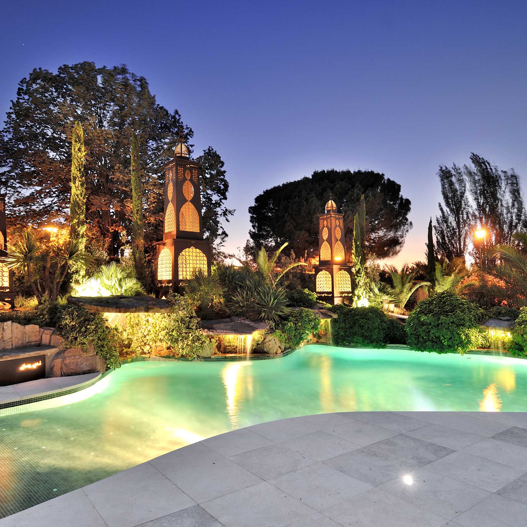 Private garden with swimming pool and lanterns.