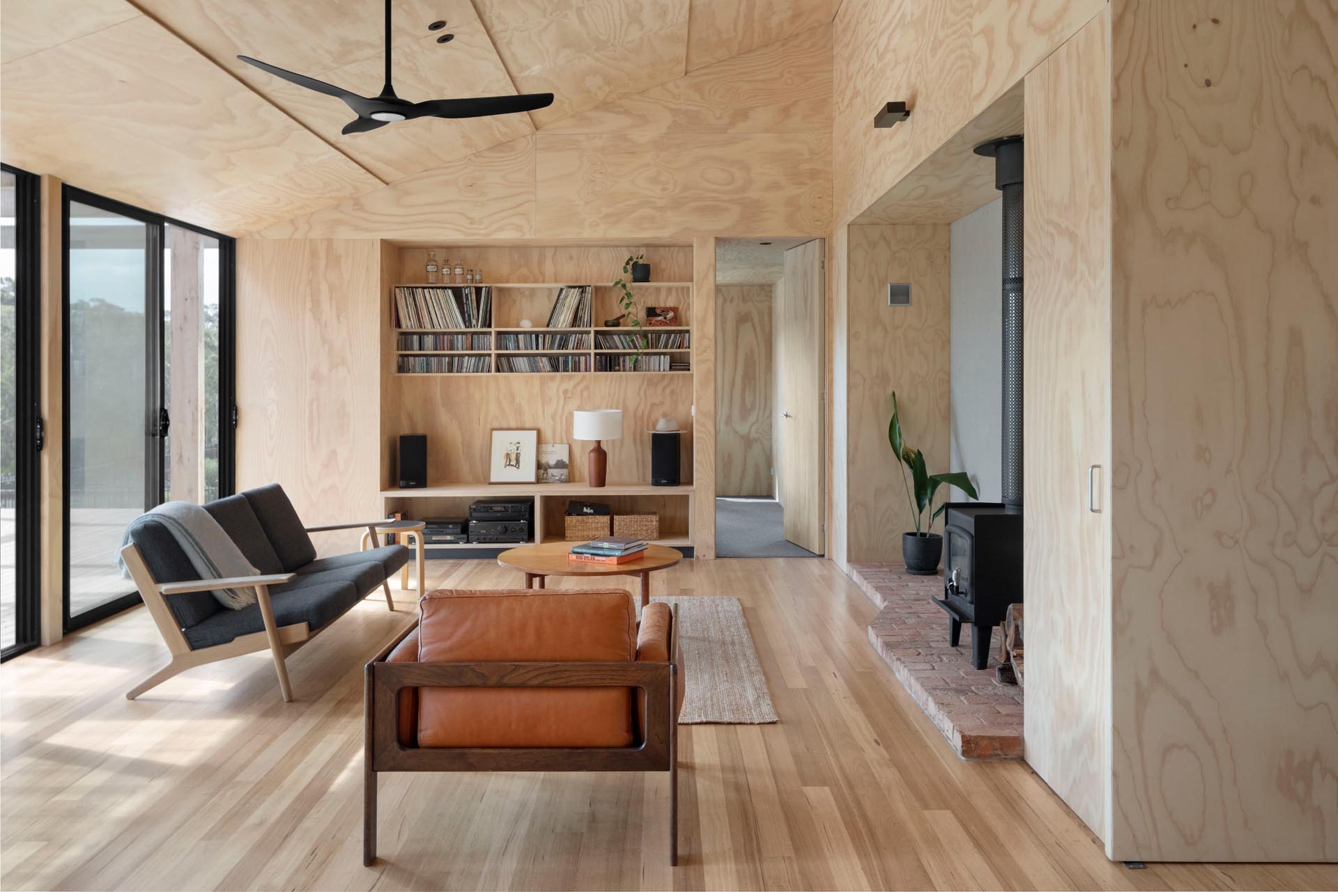 The interior of this home has been lined with plywood sheets, designed to age gracefully instead of repainting in the future. 