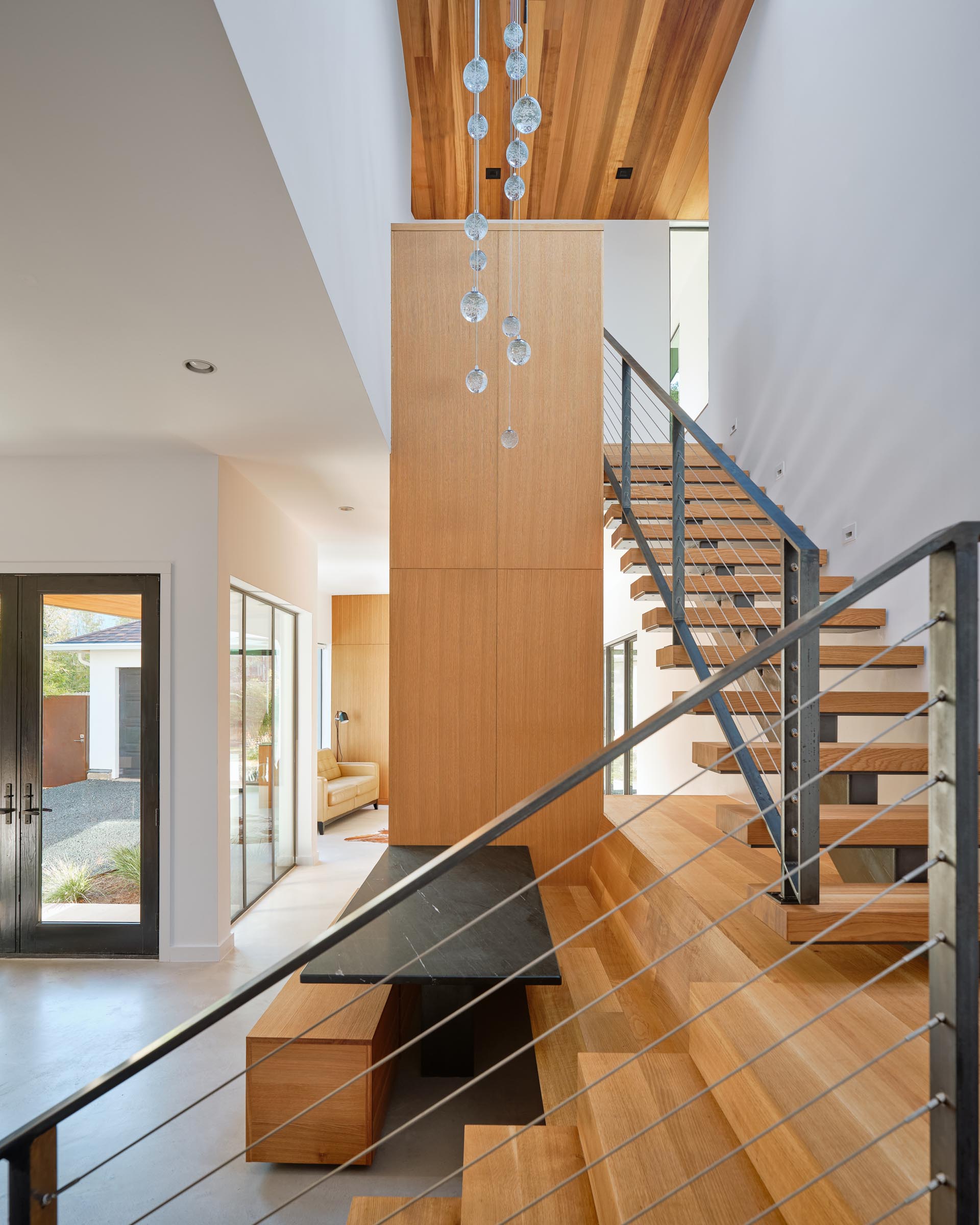 A modern built in dining area with benches and a dark table top.