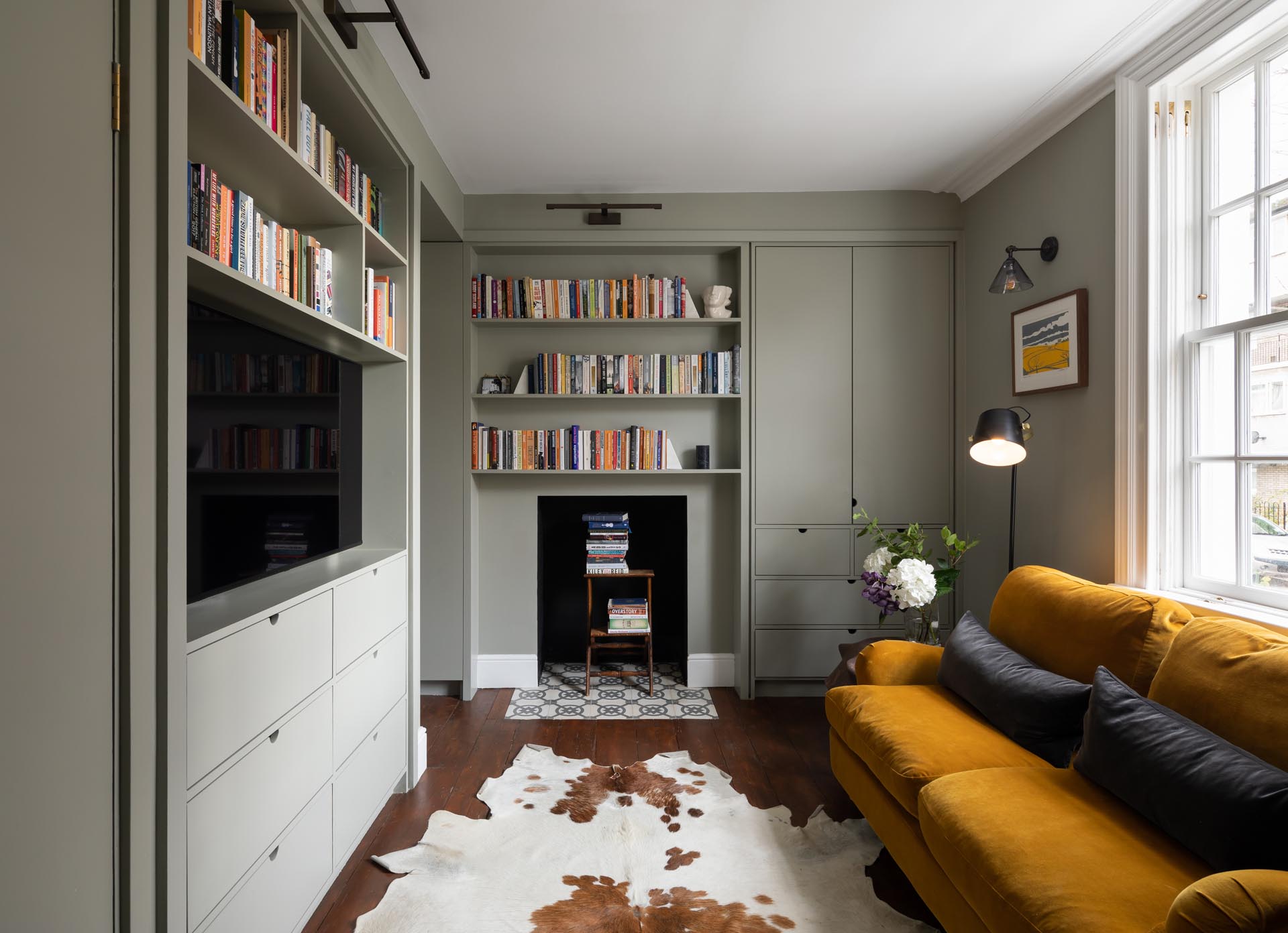 A remodeled living room with gray and white shelving.